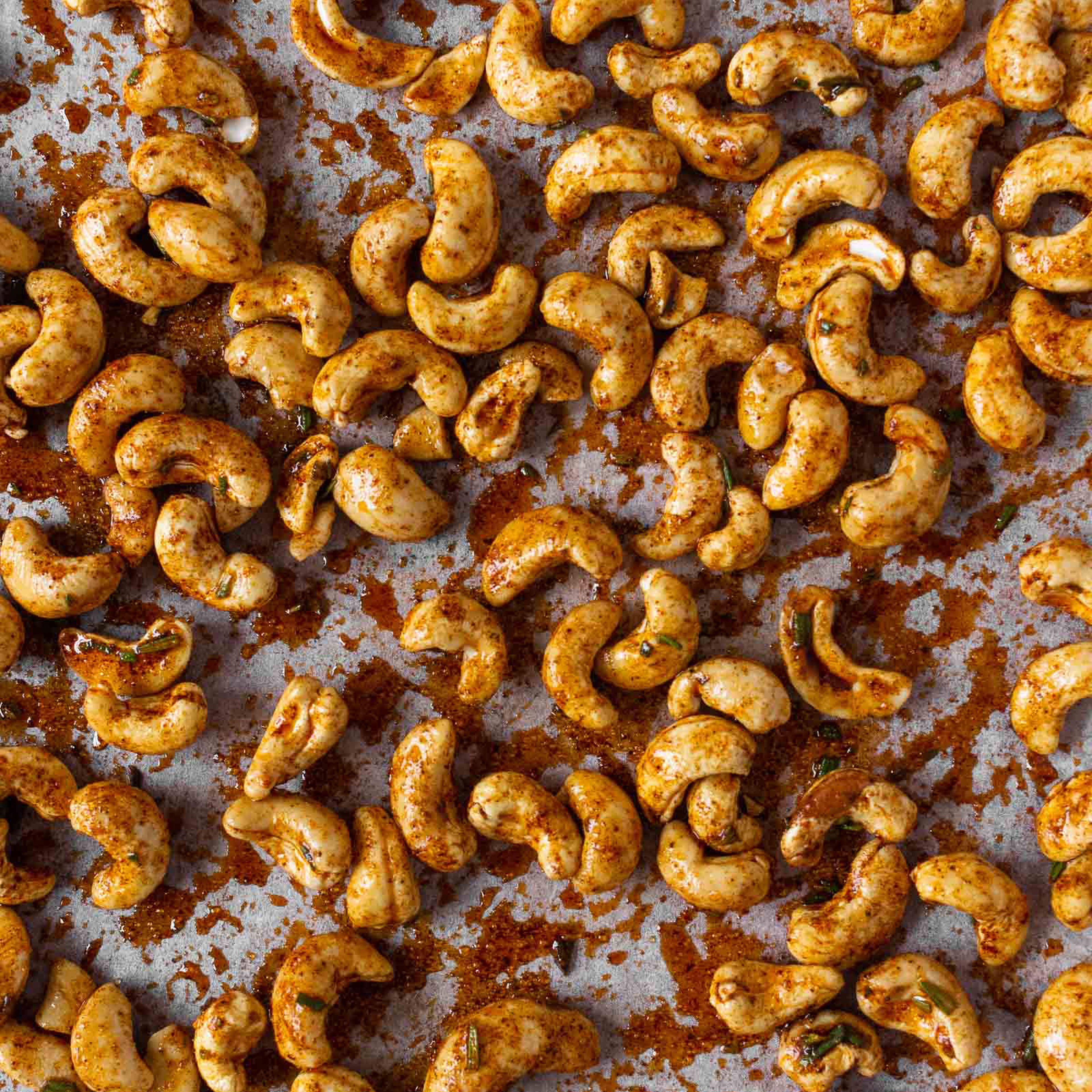 Distribute the marinated cashew nuts evenly on the baking tray, making sure they don't overlap. Roast for about 8 to 10 minutes until slightly browned.