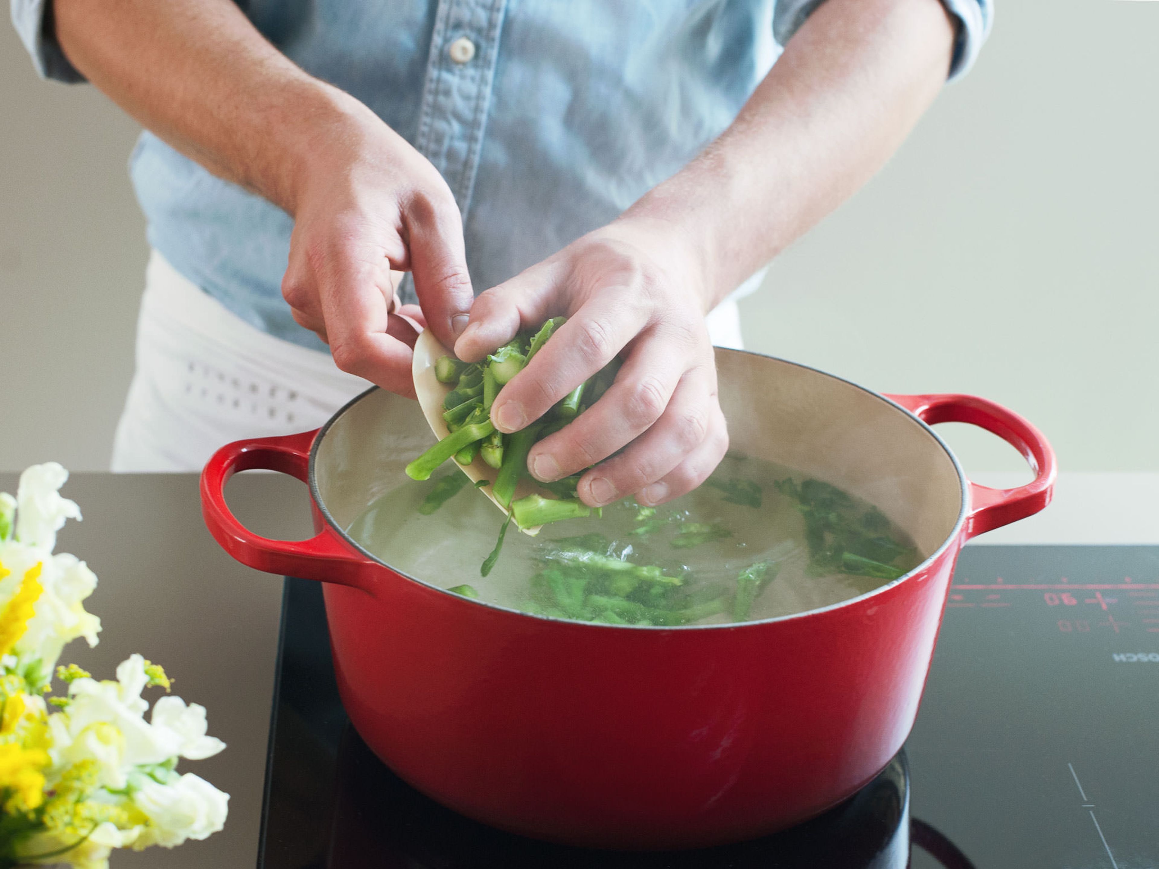 Fill a large saucepan with water and bring to a boil, then add salt. Add rapini stems and cook for approx. 1 – 2 min. until slightly tender; do not remove from water.