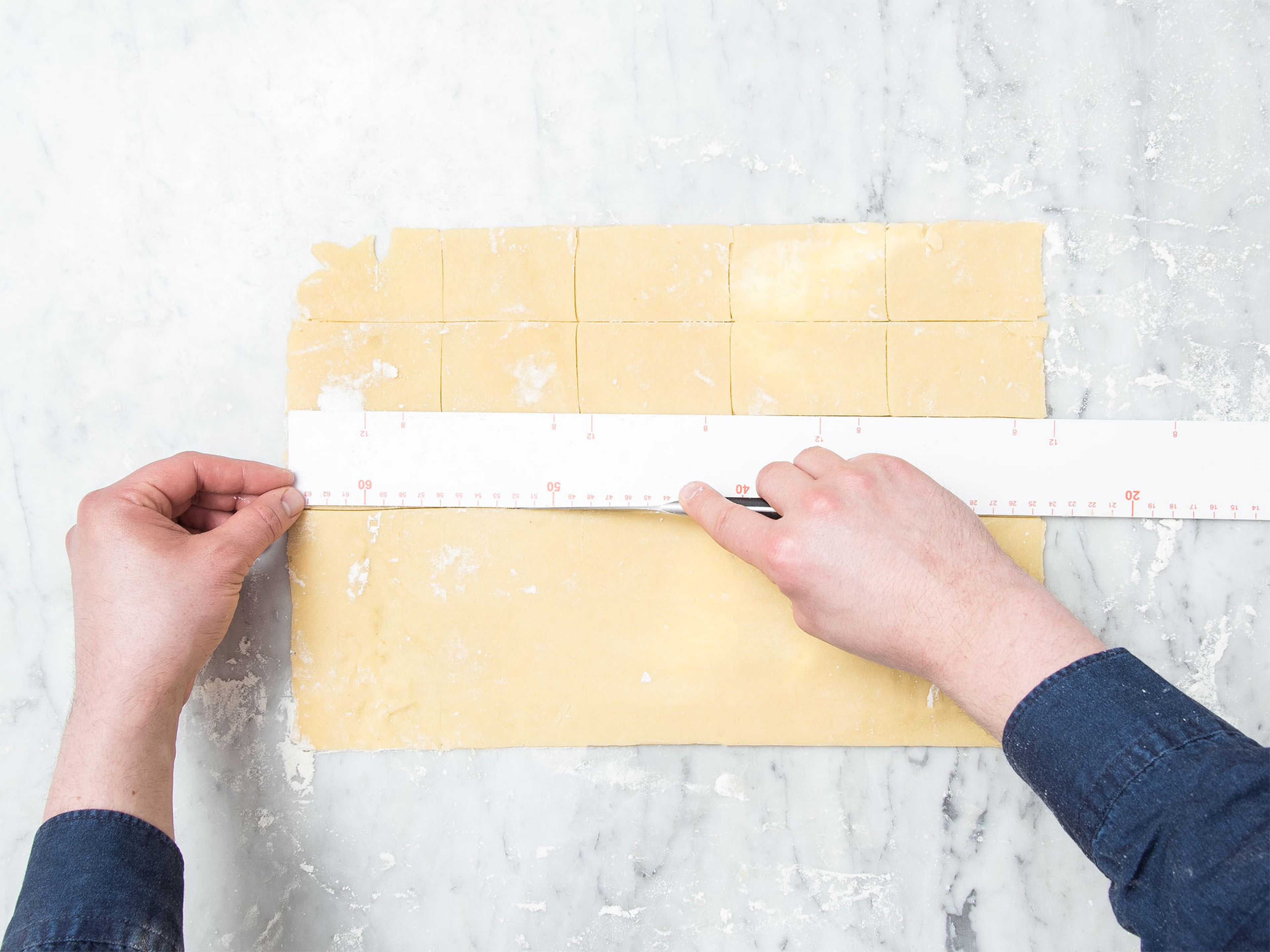 Roll out the dough on a floured work surface until approx. 3-mm/0.2-in thick. Trim the sides as needed and cut the dough into an even amount of rectangles of 5x8-cm/2x3-in. Transfer half of them onto a parchment-lined baking sheet.