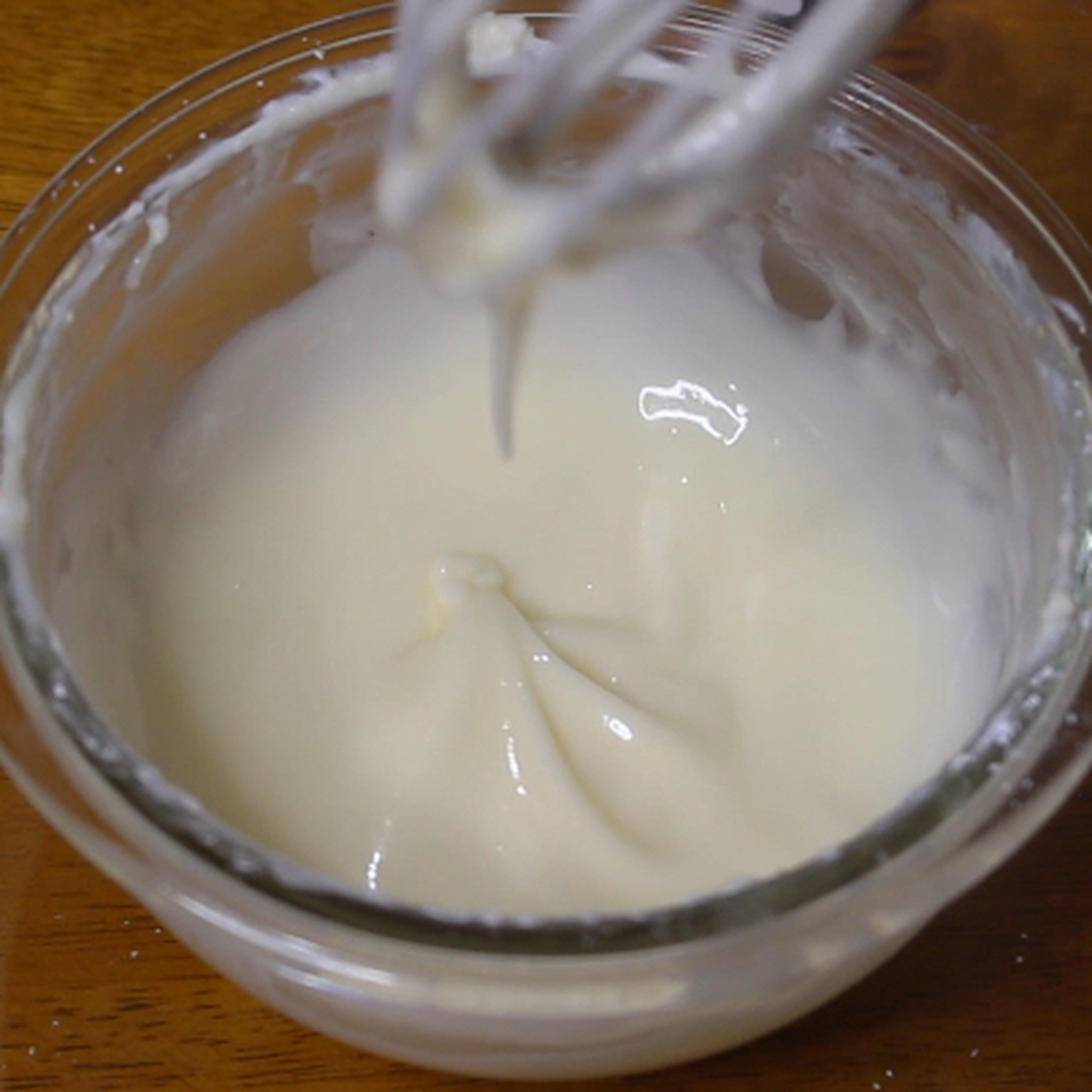 For the icing. Combine the cream cheese, confectioner's sugar, vanilla extract and whole milk in a bowl and whisk it well until smooth.