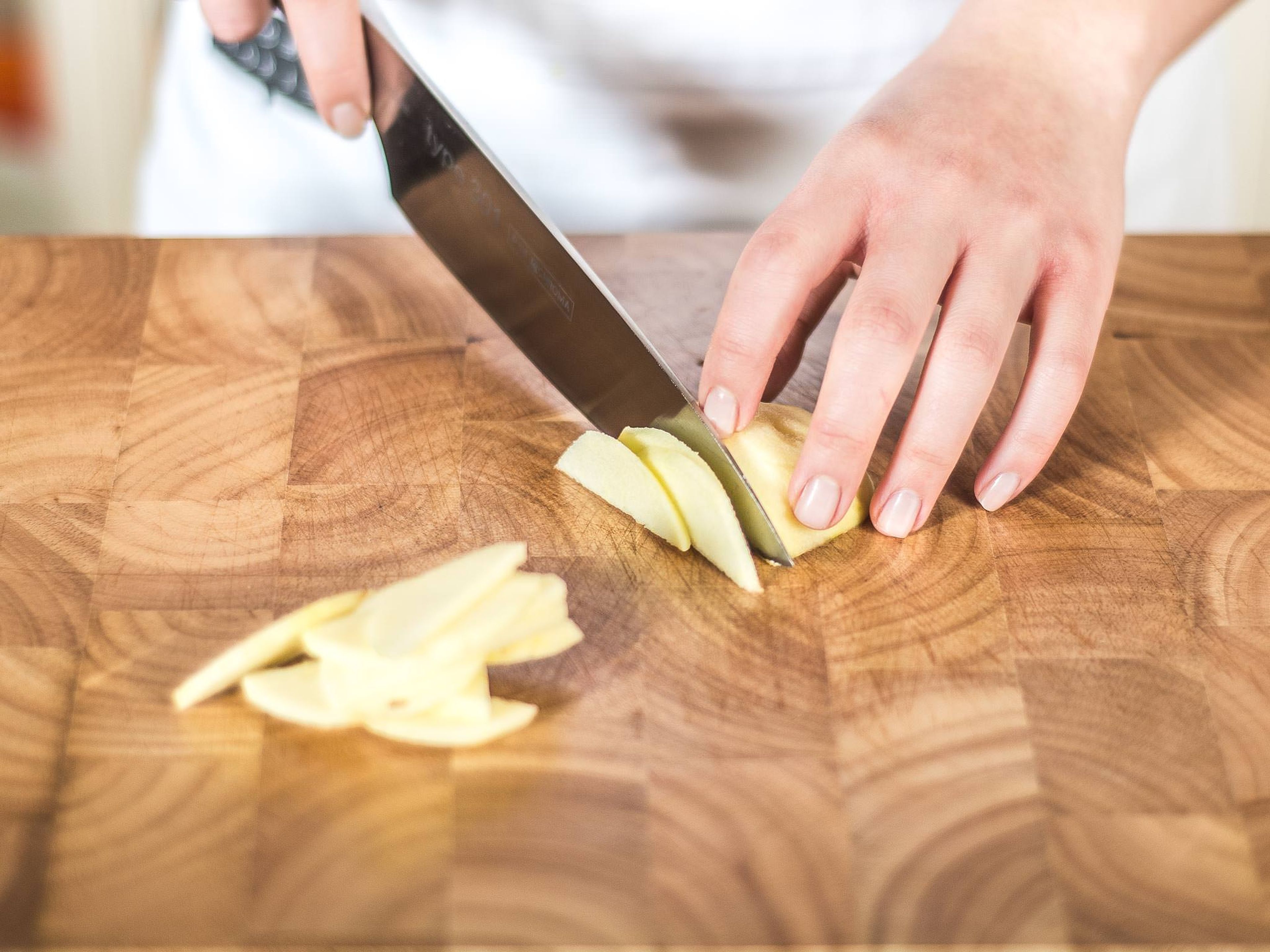 Preheat the oven to 180°C/ 350°F. Then, peel and core the apples, halve them lengthwise, and cut them into thin slices.