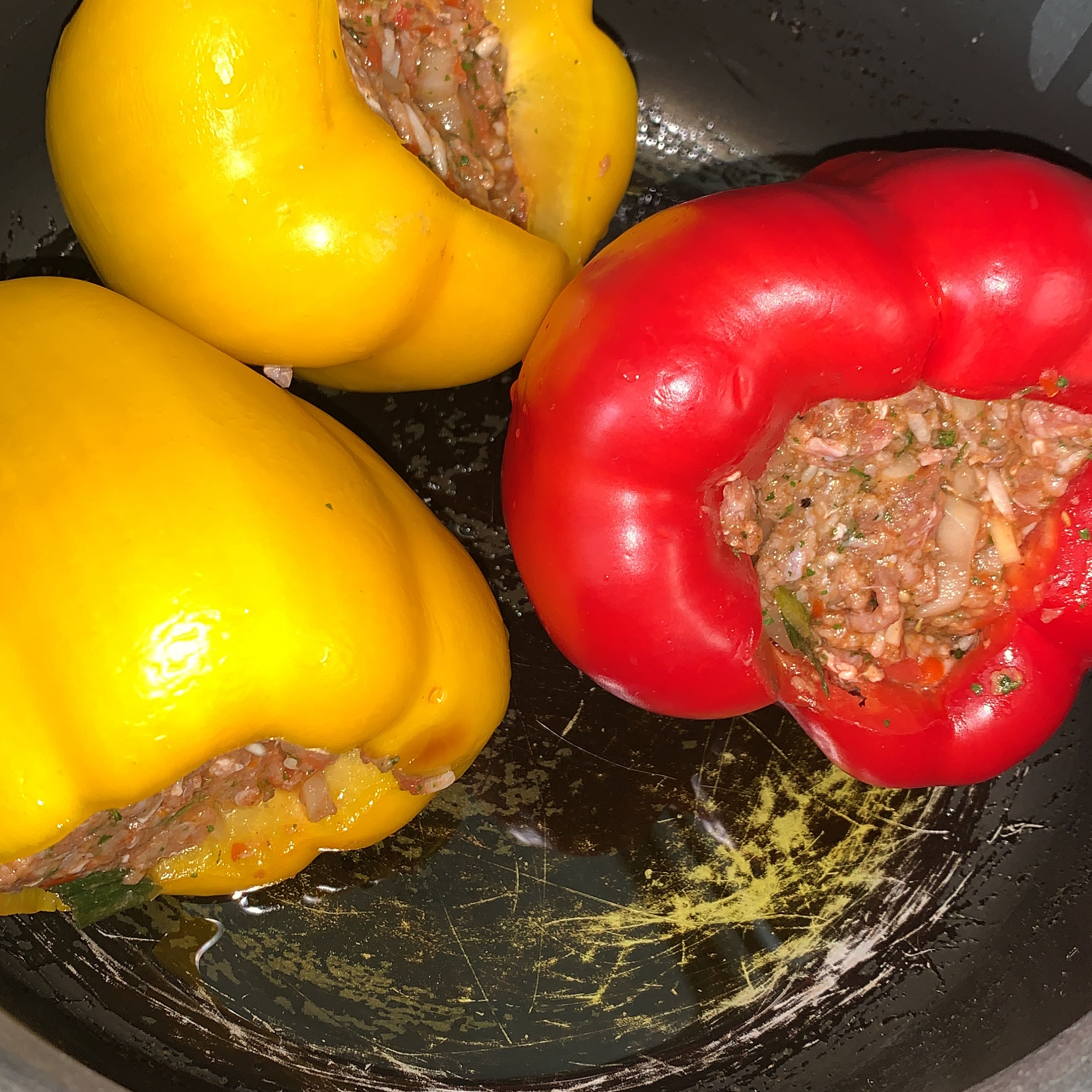 Stuff the bell peppers. Add oil to a pot and turn the heat up to medium high. Add the bell peppers and let them cook for 40 minutes. Flip the peppers halfway through.