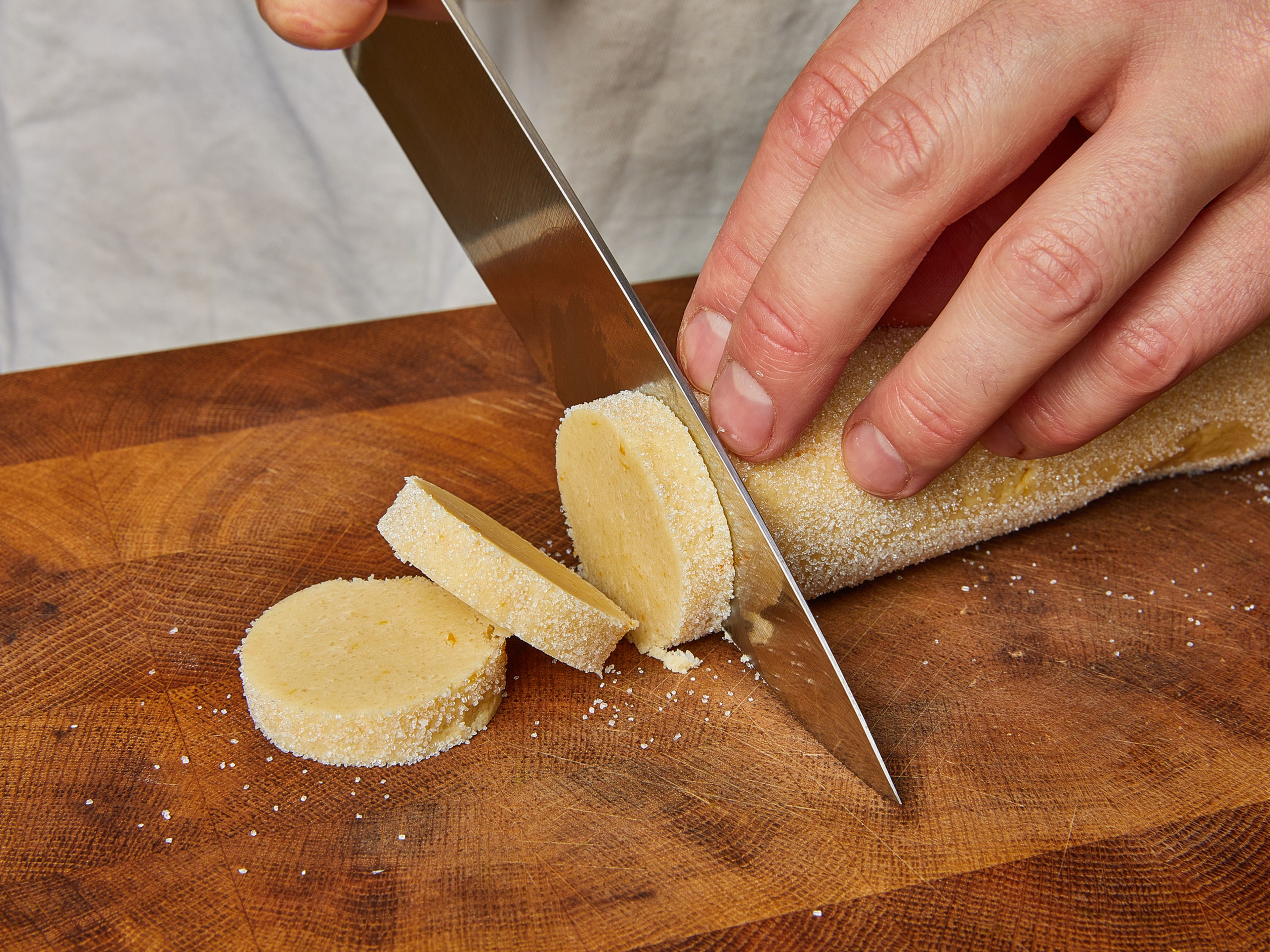 Using a sharp knife, cut the rolls into 1 cm/0.4 in. thick slices and place them on two baking sheets lined with parchment paper, approx. 2 cm/0.8 in. apart. Bake the still-frozen cookies until golden brown, for approx. 15–18 min. (the baking time is reduced to approx. 12–15 min. if the cookie dough is no longer frozen). Let cool on a wire rack. Top with melted chocolate if desired.