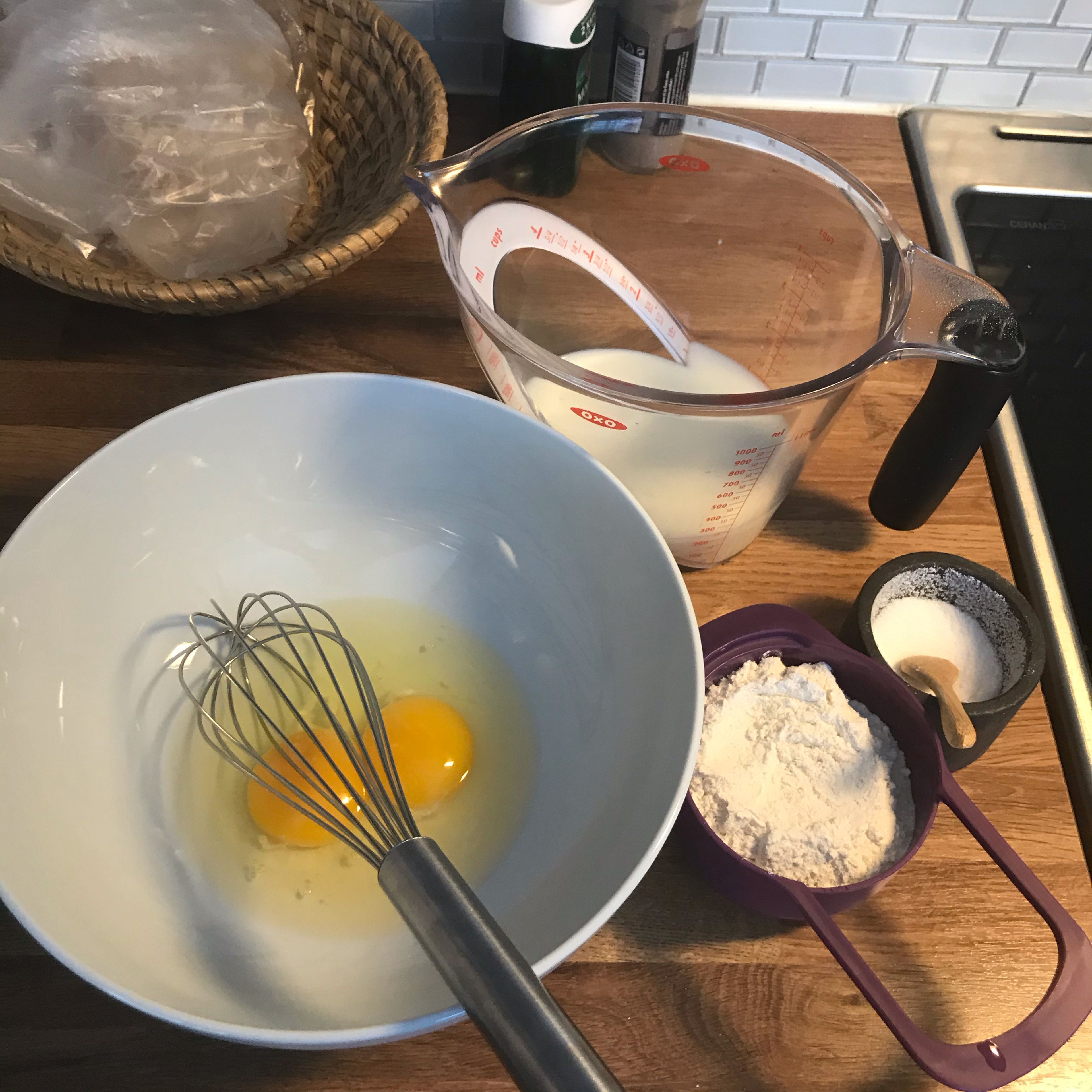 In a large mixing bowl, whisk together the flour and the eggs. Gradually add in the milk while, stirring to combine. Add the salt and oil and beat until smooth.