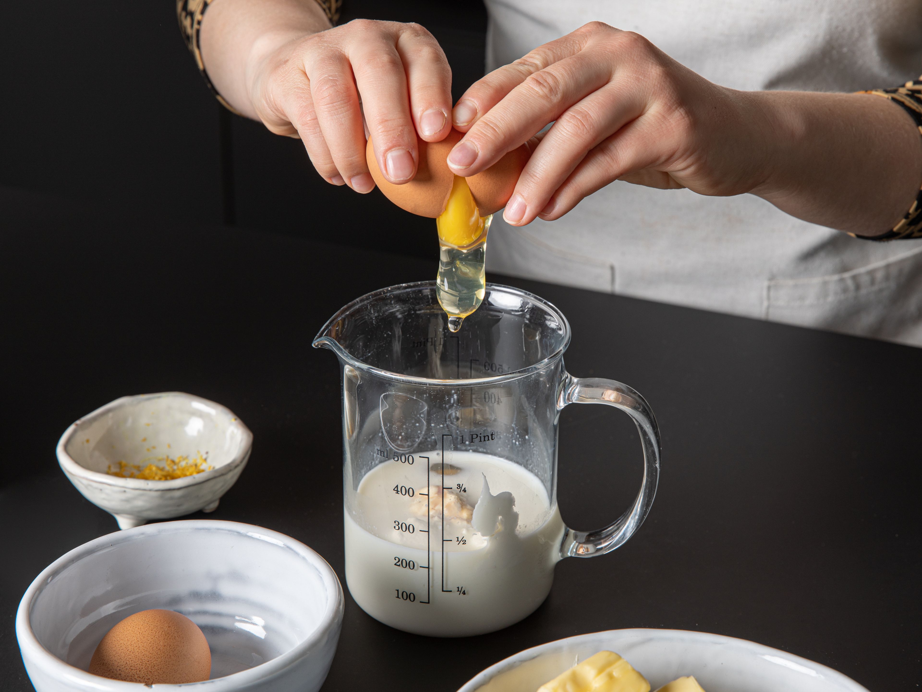 Grease the springform pan and line with baking paper. Mix flour with baking powder, baking soda, sugar, and salt in the bowl of a stand mixer. Whisk eggs, milk, vanilla extract, yogurt, and lemon zest in a liquid measuring cup.