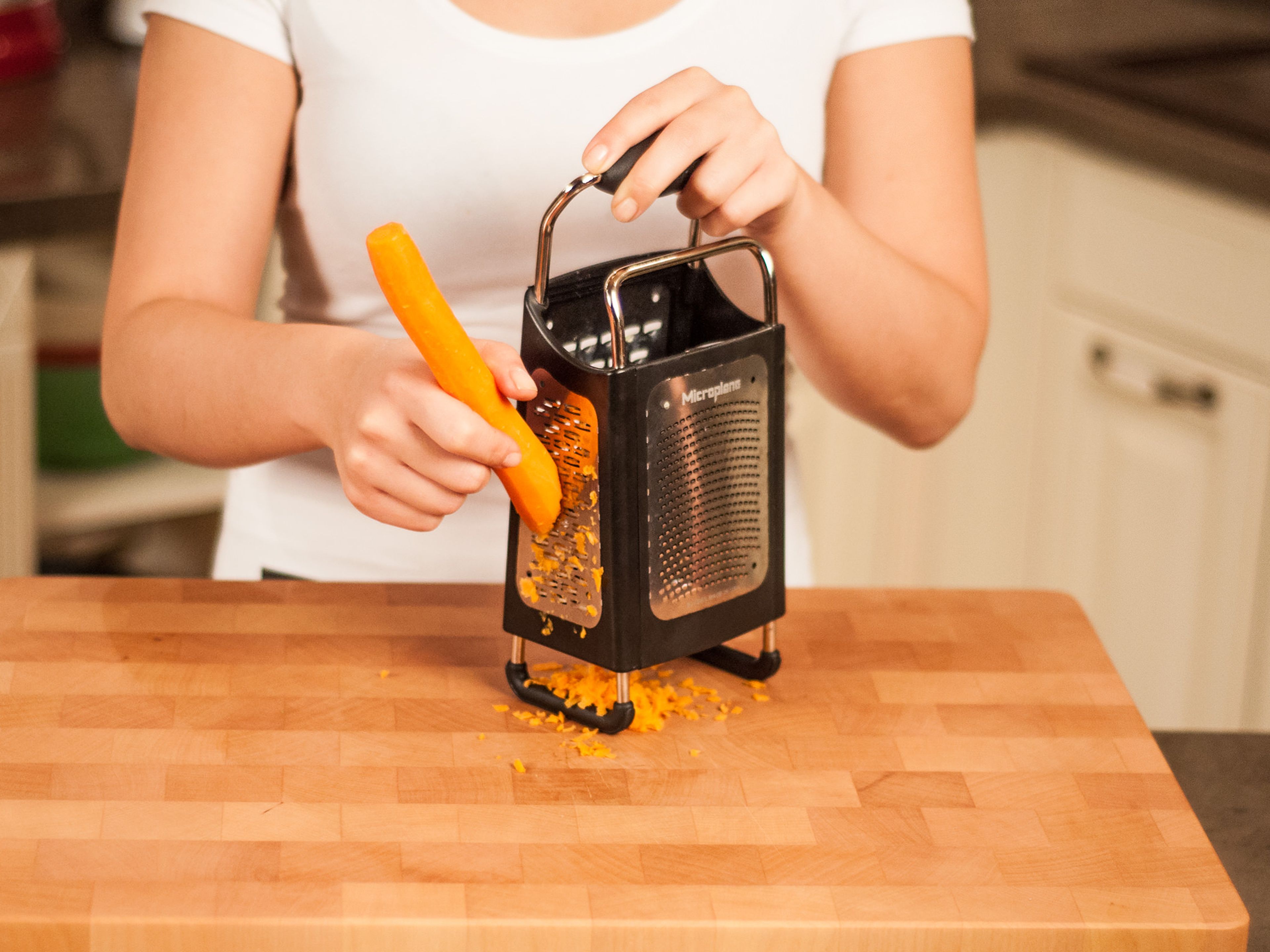 In the meantime, roughly grate carrot using a box grater.