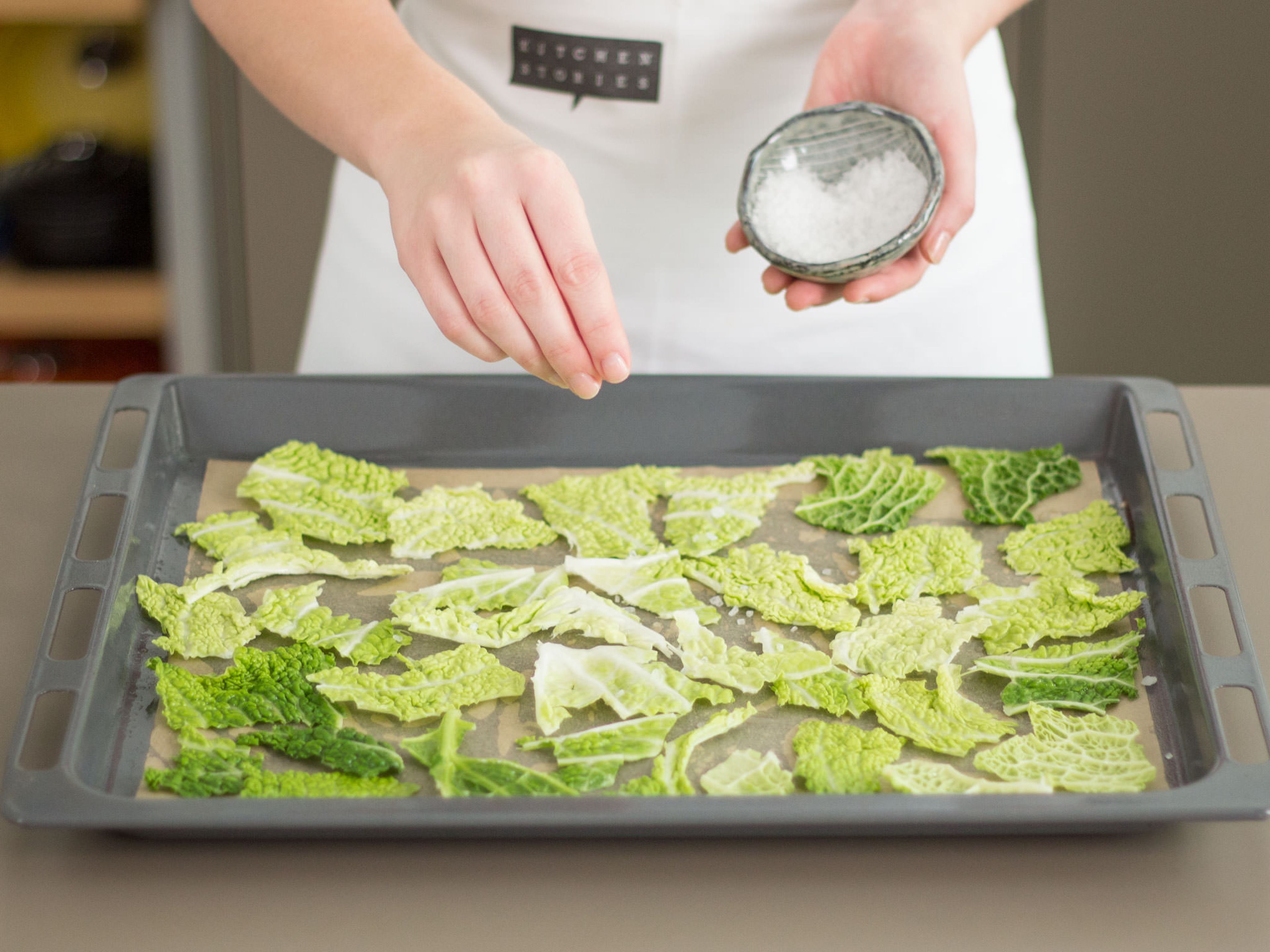 Arrange cabbage on a parchment paper-lined baking sheet. Drizzle with vegetable oil. Sprinkle sea salt on top. Bake in preheated oven at 180°C/355°F for approx. 10 – 15 min. until crispy.