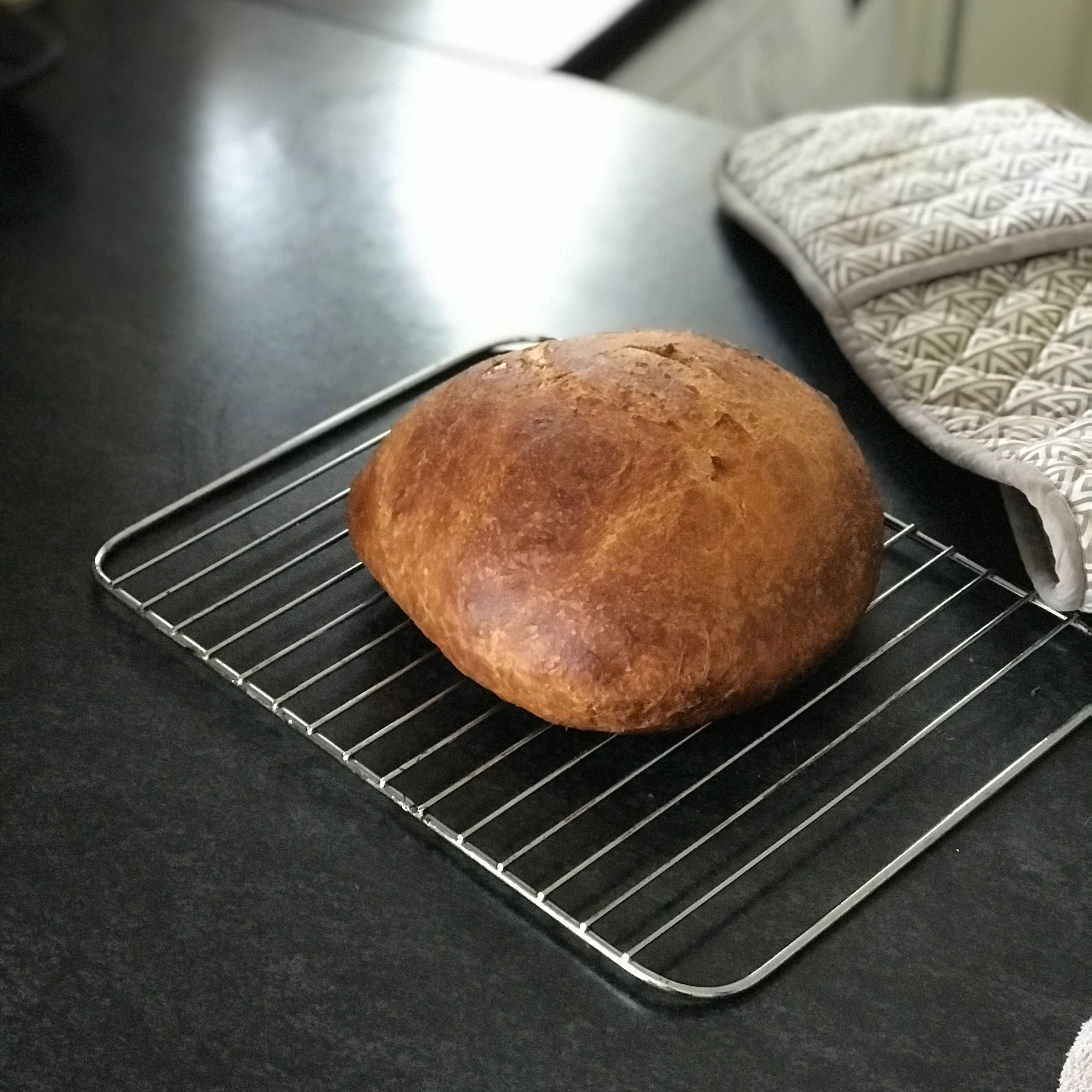Then when the time is finished take the cast Iron pot out of the oven and put the Bread on a metal rack and live it to cool down for about 30 min. Then you can cut it and enjoy it.