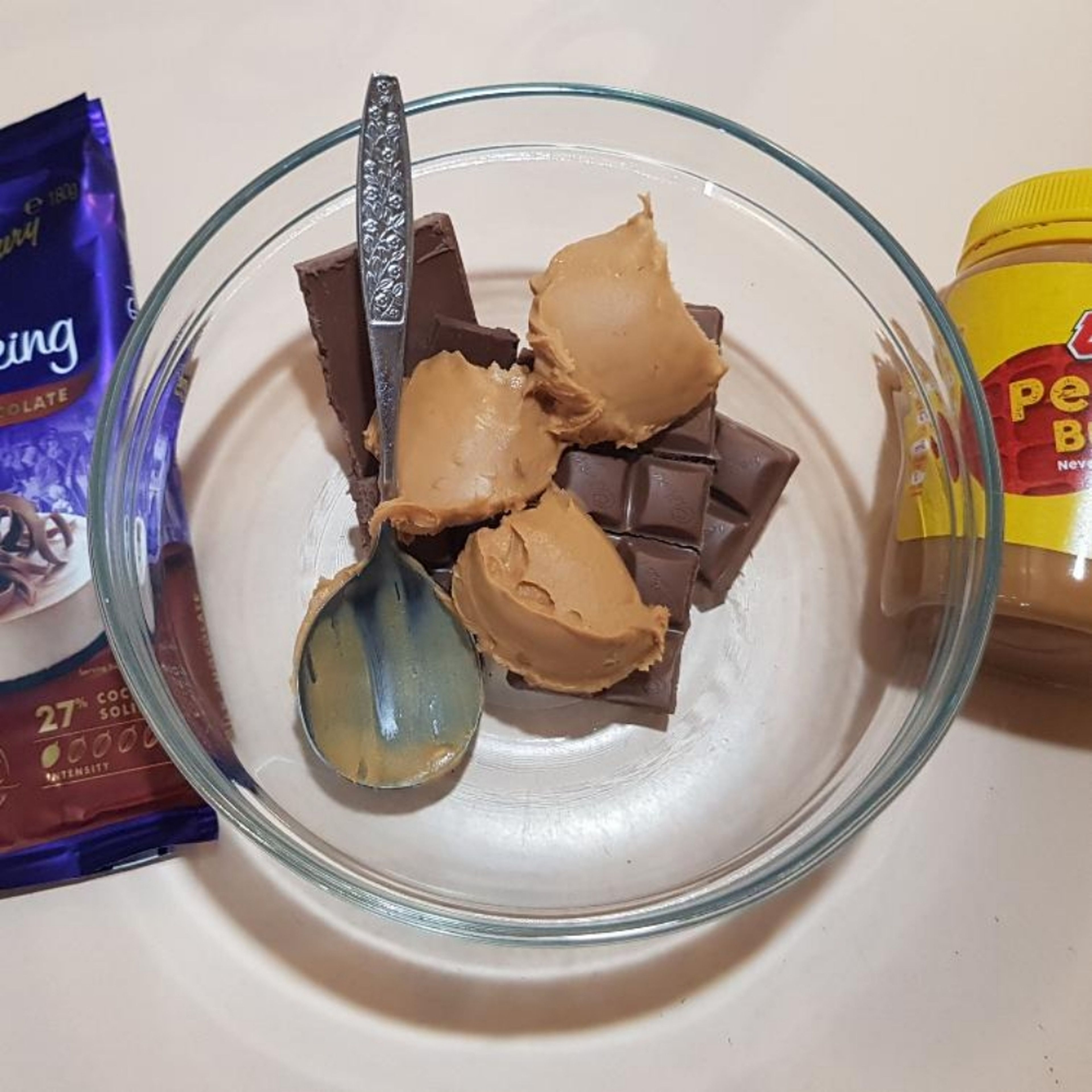 Melt chocolate & peanut butter together in the microwave in a microwave proof bowl. Do it slowly so you don't burn the chocolate. Check approximately every 20 seconds. See if your microwave has a "melt" setting.