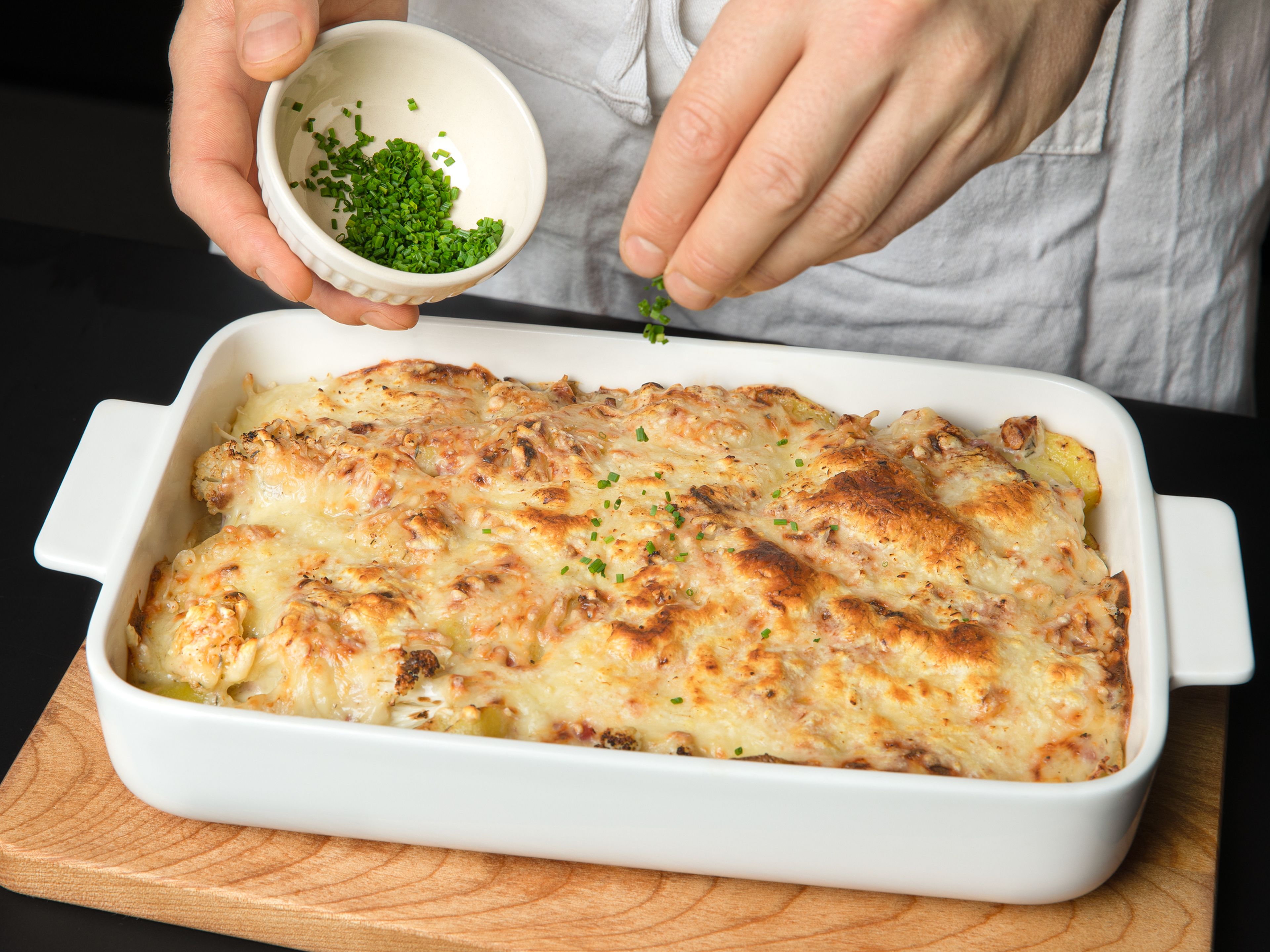 After baking, let the casserole cool slightly and then serve garnished with chives.