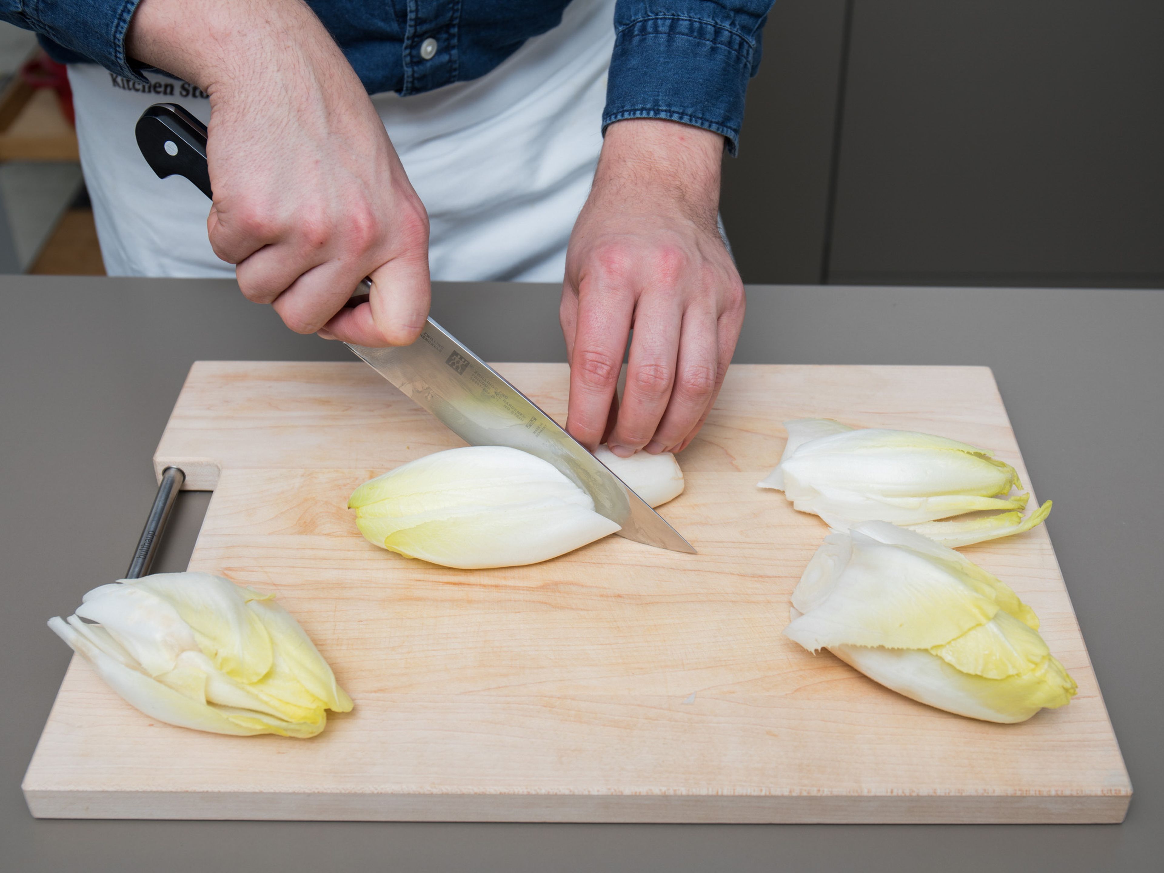 Remove the outer leaves of each endive, discarding any that are wilted or discolored. Then, slice in half lengthwise.