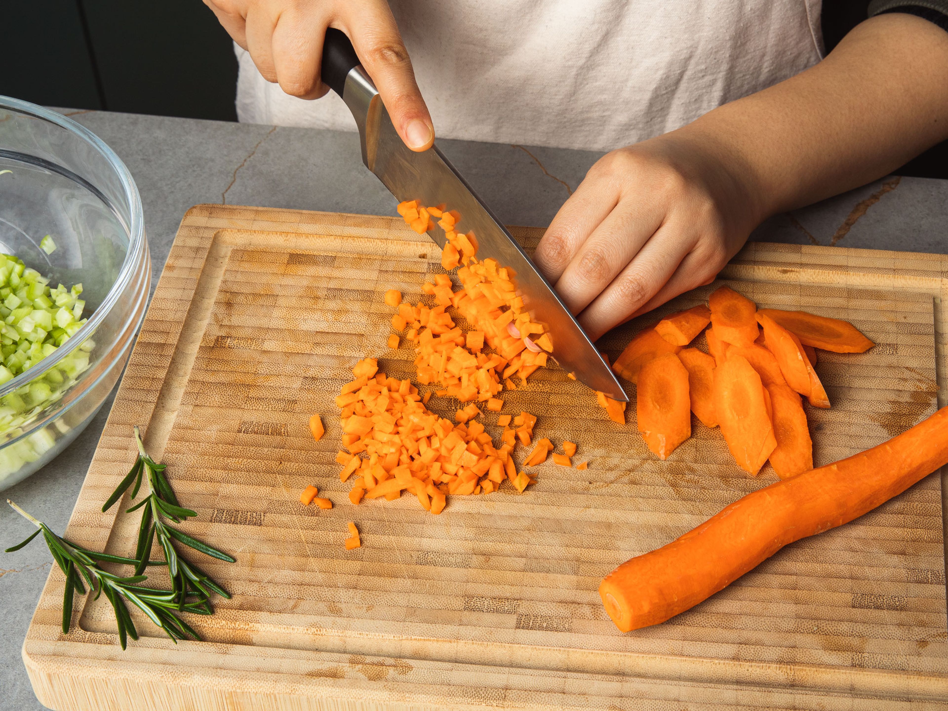 Finely dice garlic, onion, carrot and celery, or use a food processor to chop them into small pieces. Add to a bowl. Drain canned white beans in a sieve.