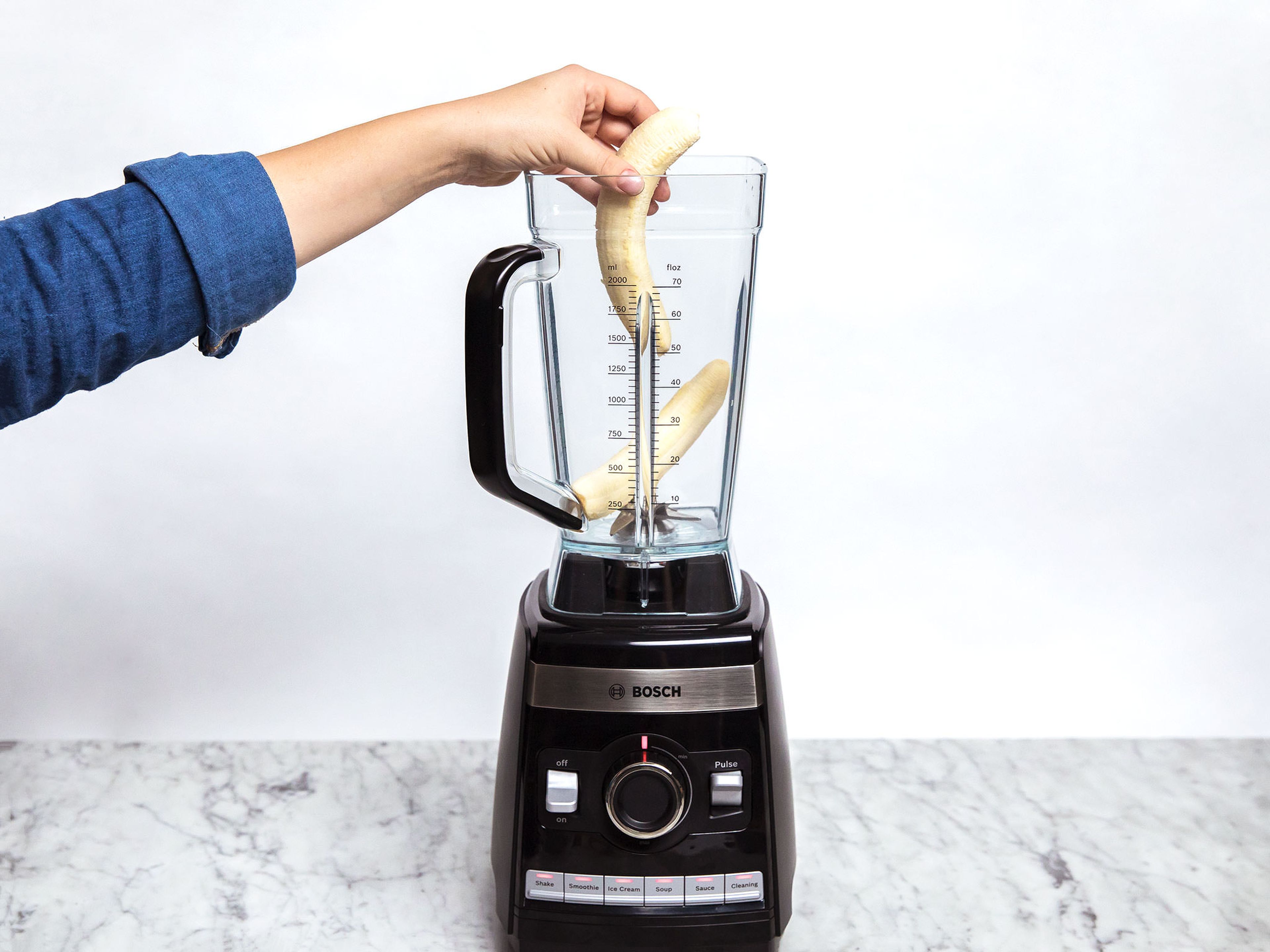 Peel the bananas and add to the blender.
