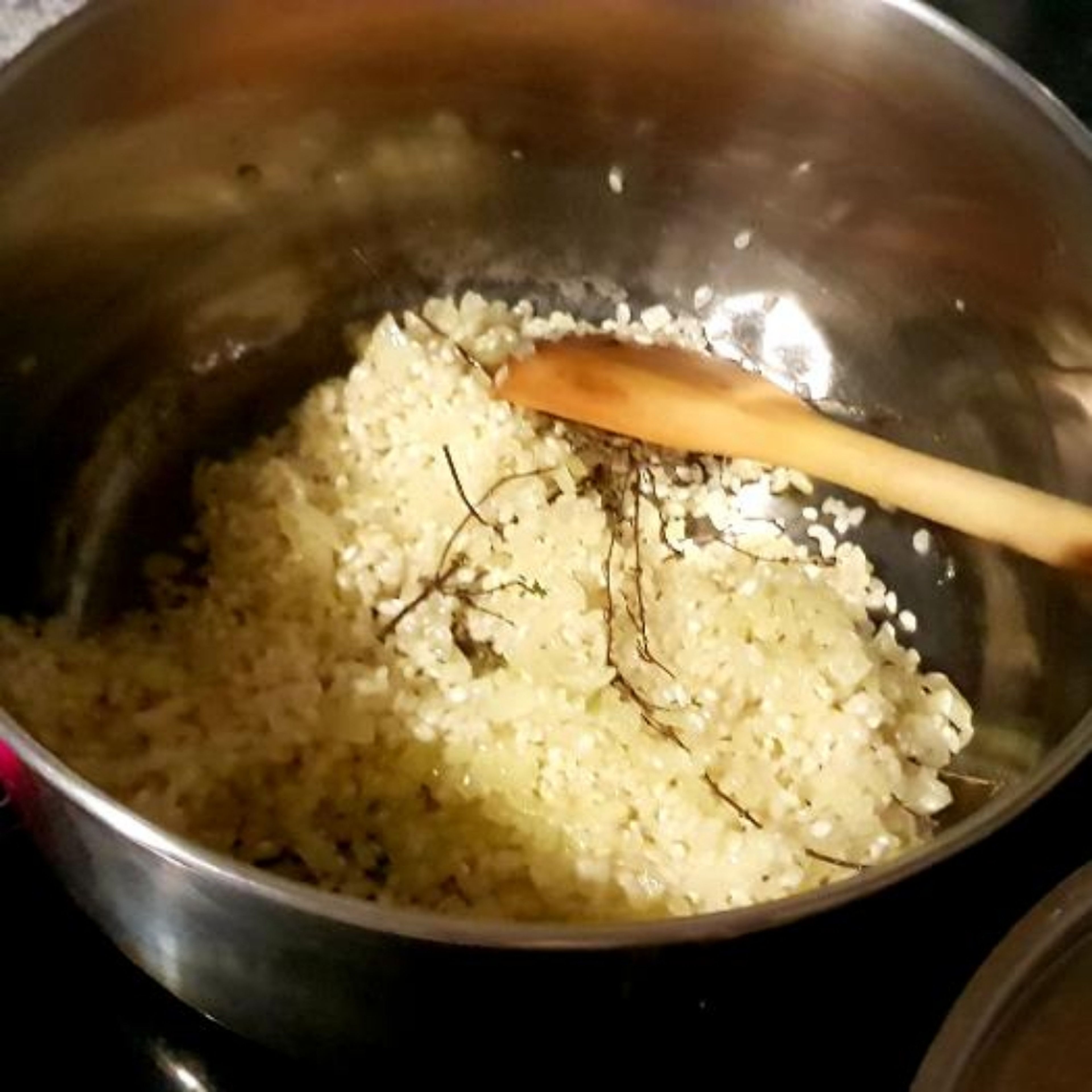 Reis und Thymian dazugeben und kurz anbraten. Je die Hälfte der Sahne und der Gemüsebrühe dazugeben. Mit Salz, Pfeffer und Cayennepfeffer würzen und gut vermischen.