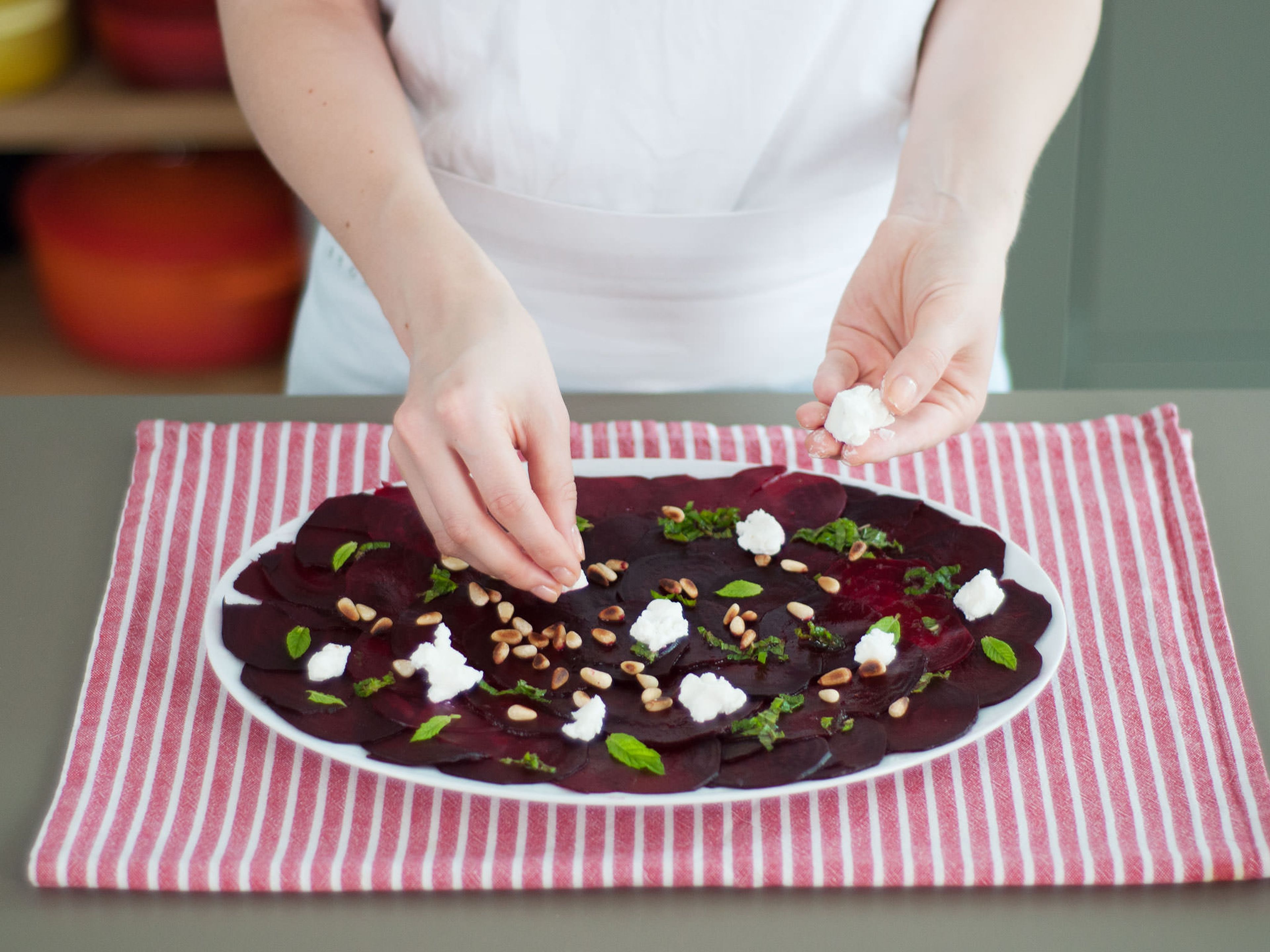Arrange beets in an even layer on a plate. Pour vinaigrette over beets, add salt and pepper to taste, and garnish with pine nuts, goat cheese, and remaining mint leaves. Enjoy!