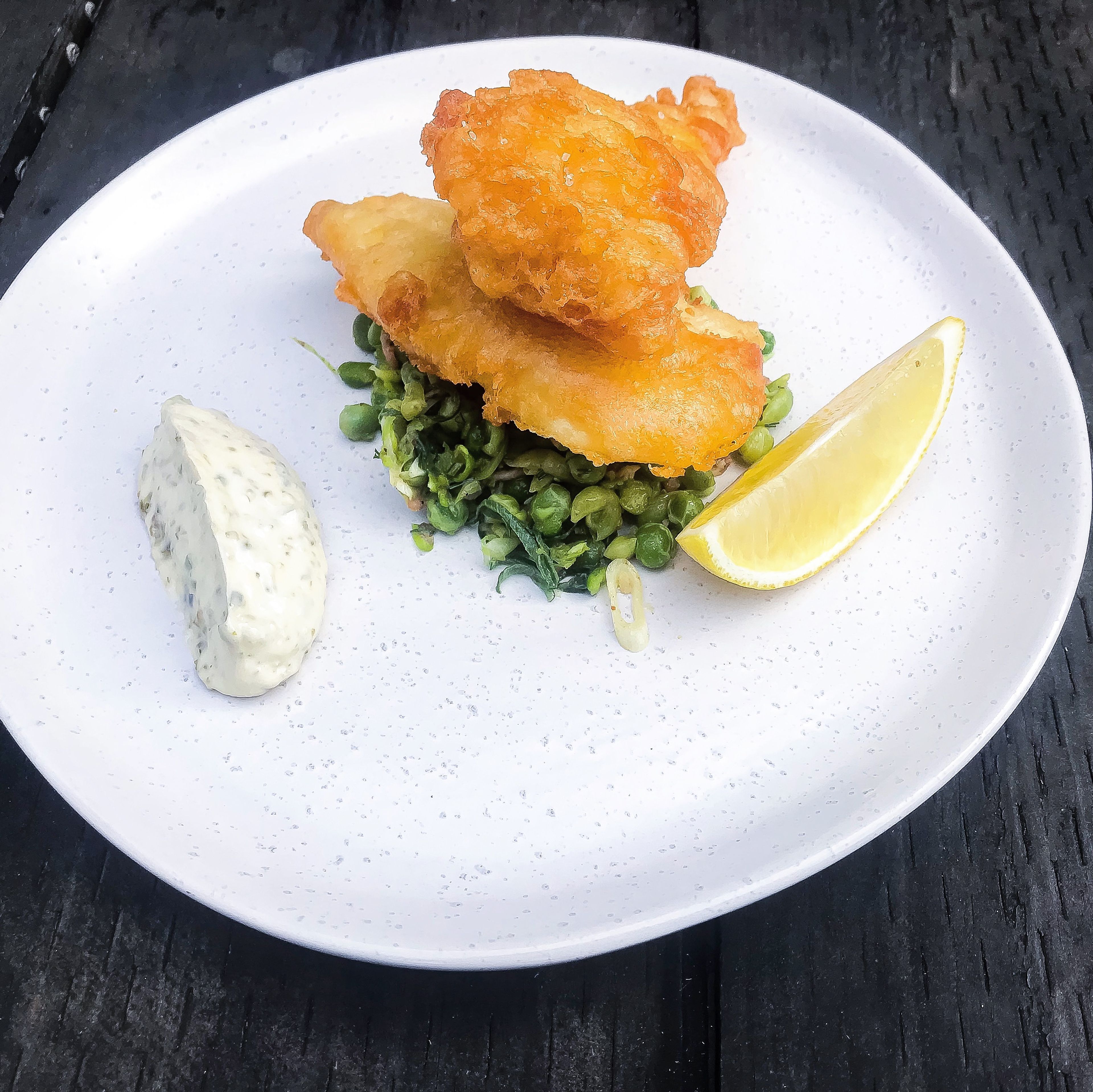 To serve, place the fish on top of the crushed peas and serve with a wedge of lemon and a healthy dollop of tartare sauce