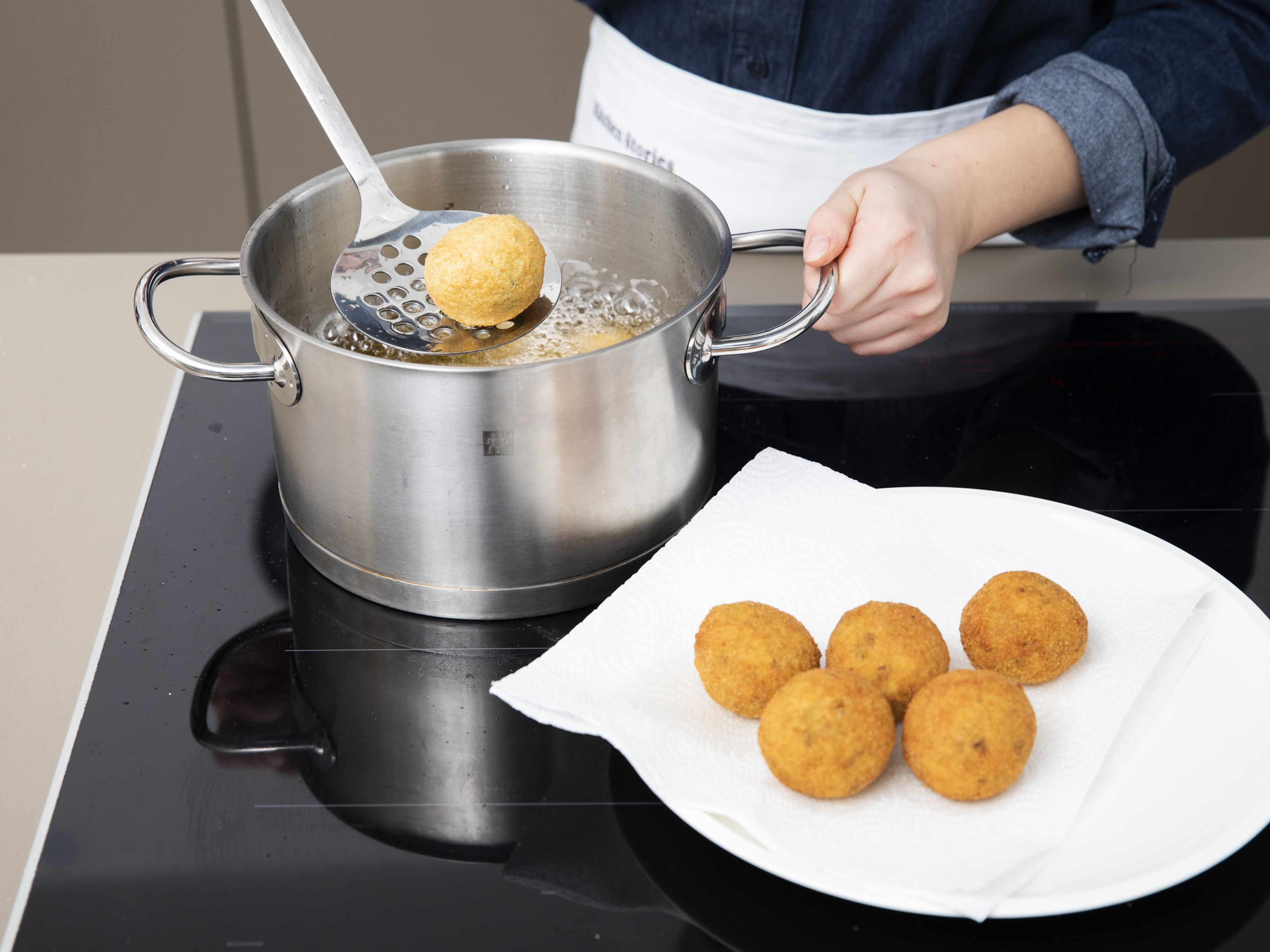 Heat vegetable oil in a small pot until it’s approx. 180°C/350°F. Add arancini in batches and deep-fry them for approx. 6 – 7 min., or until they are crispy and golden brown. Transfer to paper towels to drain and serve warm arancini with lemon wedges and yogurt for dipping. Enjoy!