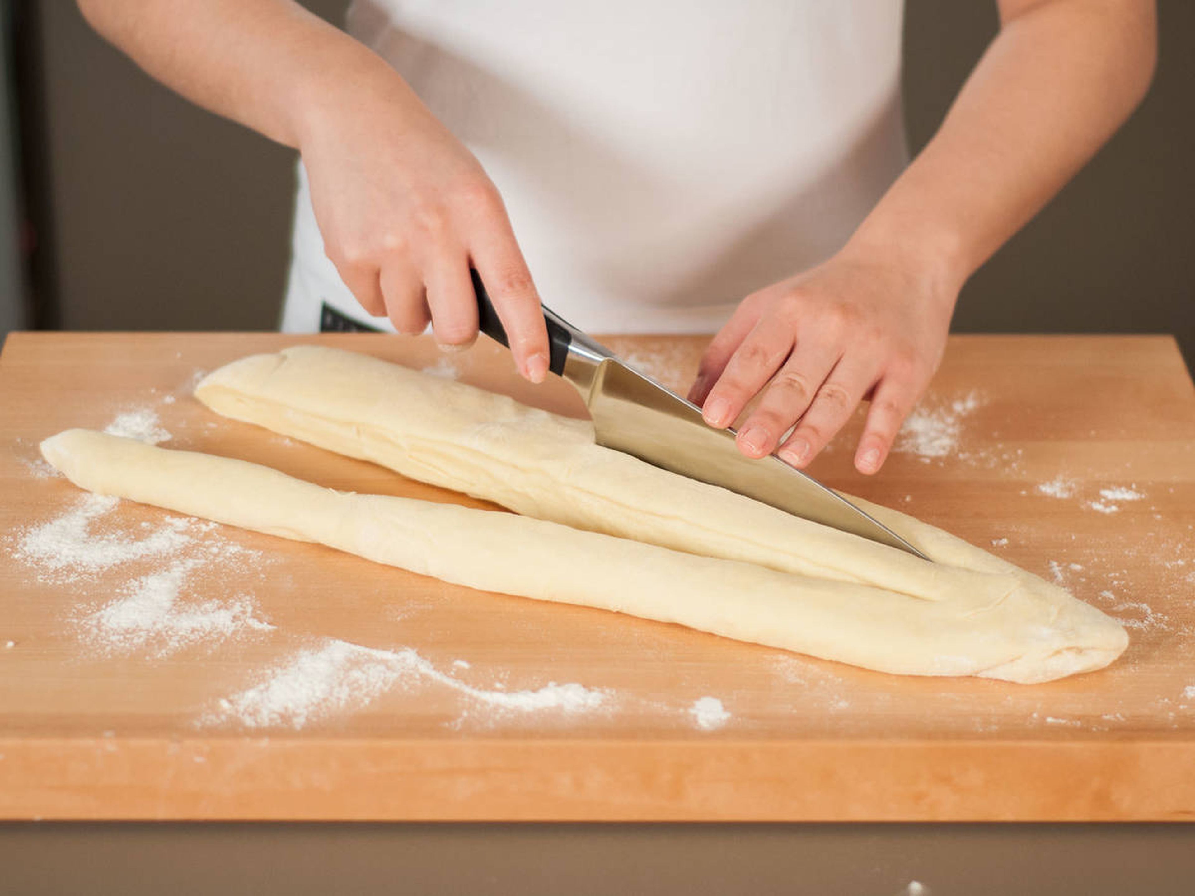 Transfer dough to a lightly floured cutting board. Knead and form a log. Carefully flatten the log with your hands. With a sharp knife, separate the dough into three strings. Make sure to leave the upper part intact.