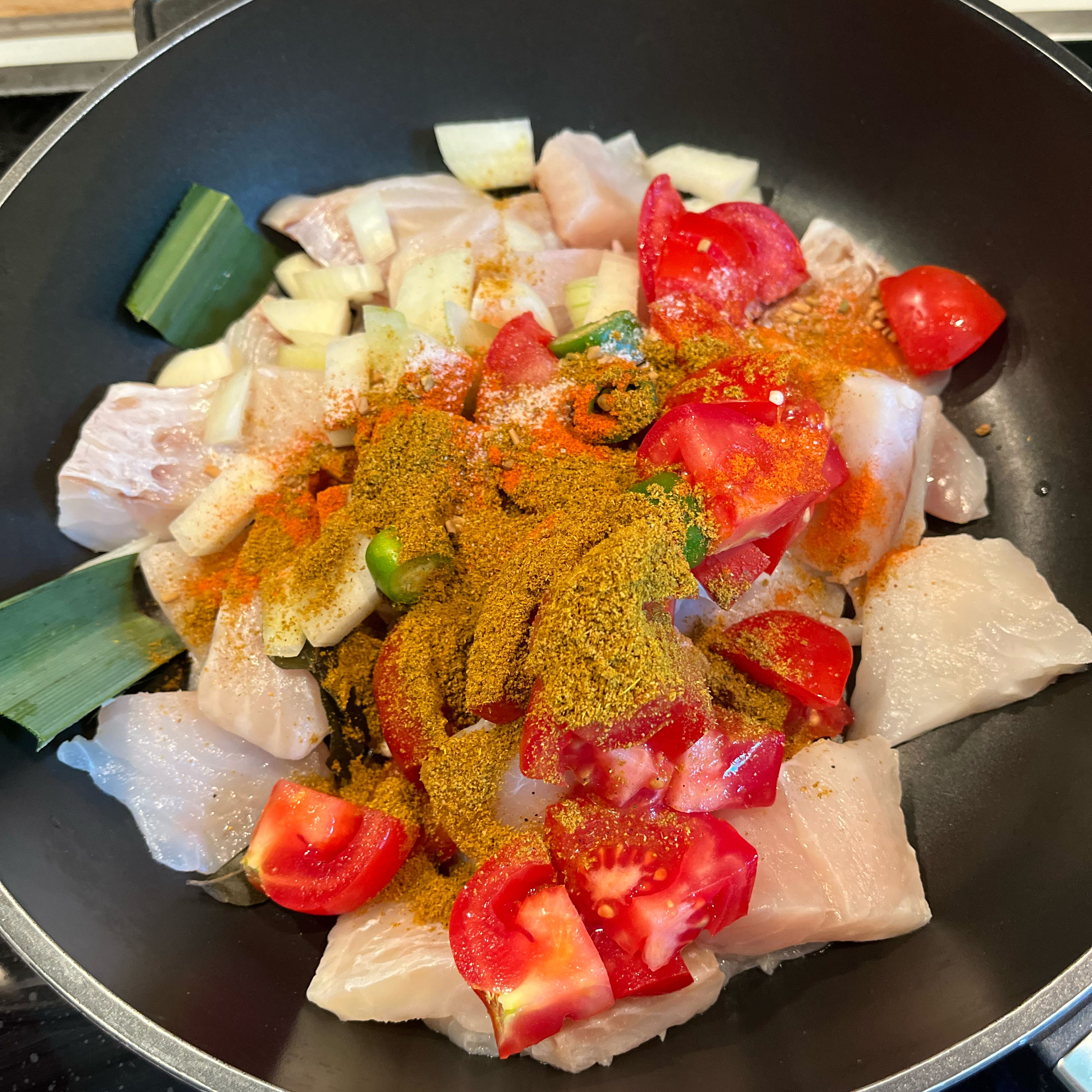 Wash the fish and transfer it to a chatty with all prepared ingredients and spices. Add lemon juice and coconut milk. Mix gently and bring to a boil.