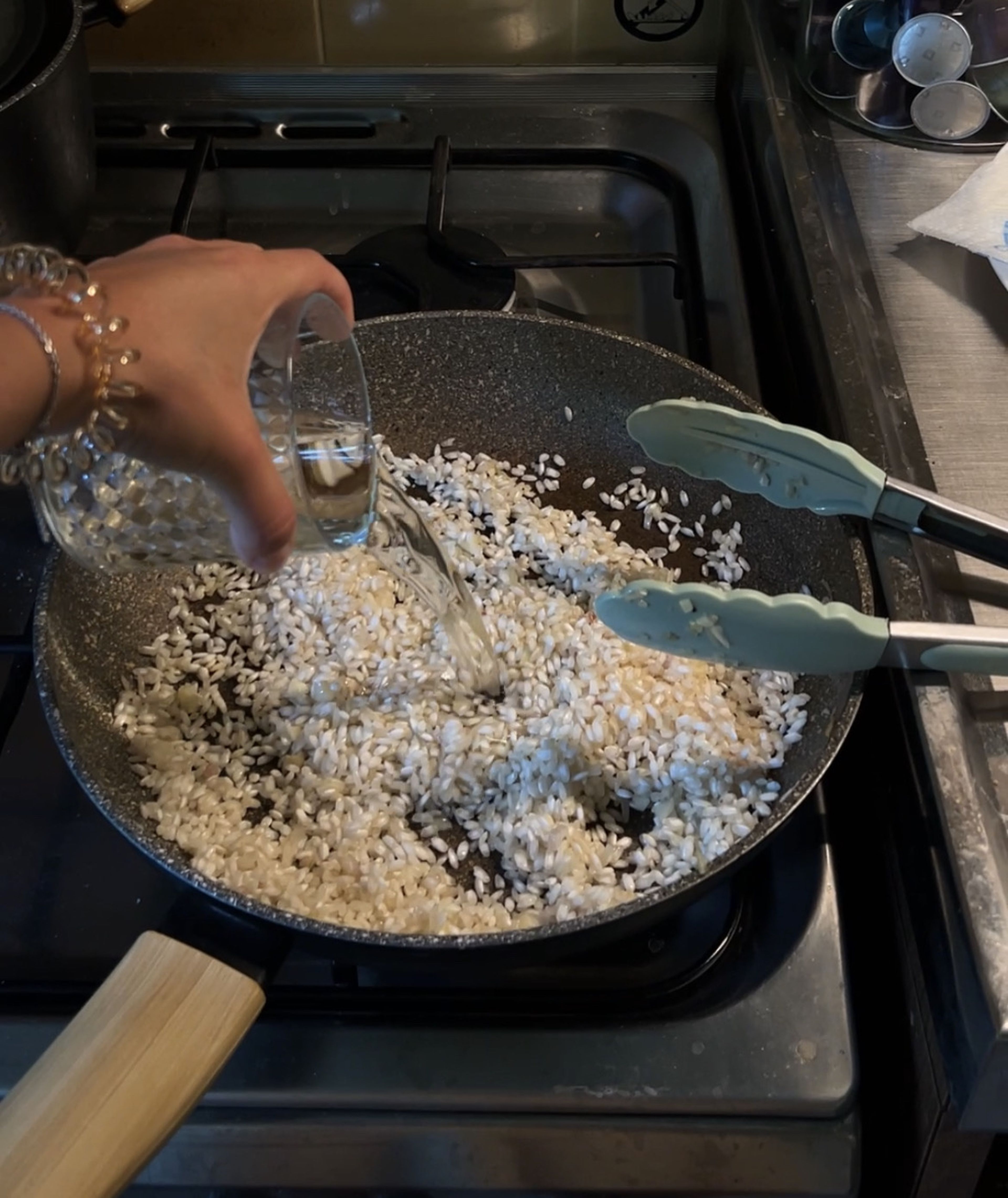 Now the assembling process, take the pan from the mushrooms, put over medium heat, add olive oil, finely copped shallots and garlic, cook them for a min and add rice, stir all together and toast the rice for 2 min in the oil, it'll soak all the flavours from the onion, garlic and olive oil. Then add wine and  cook, stirring, until liquid is absorbed for 3-5 min.