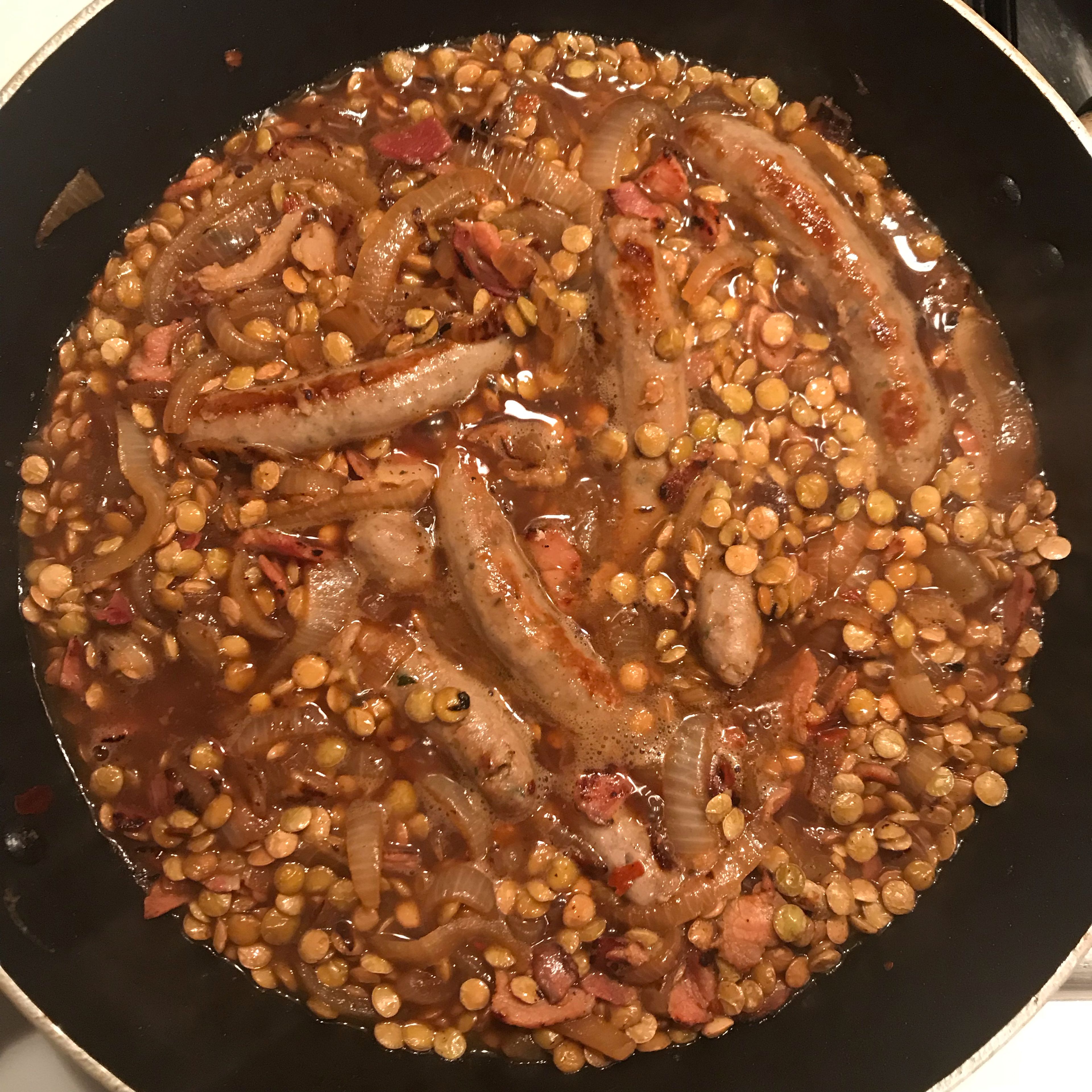 Season, turn down to simmer and put sausages back. Don’t let the lentils get too soft - keep testing them. The stock and wine should get absorbed by the lentils. Add more if needed. 