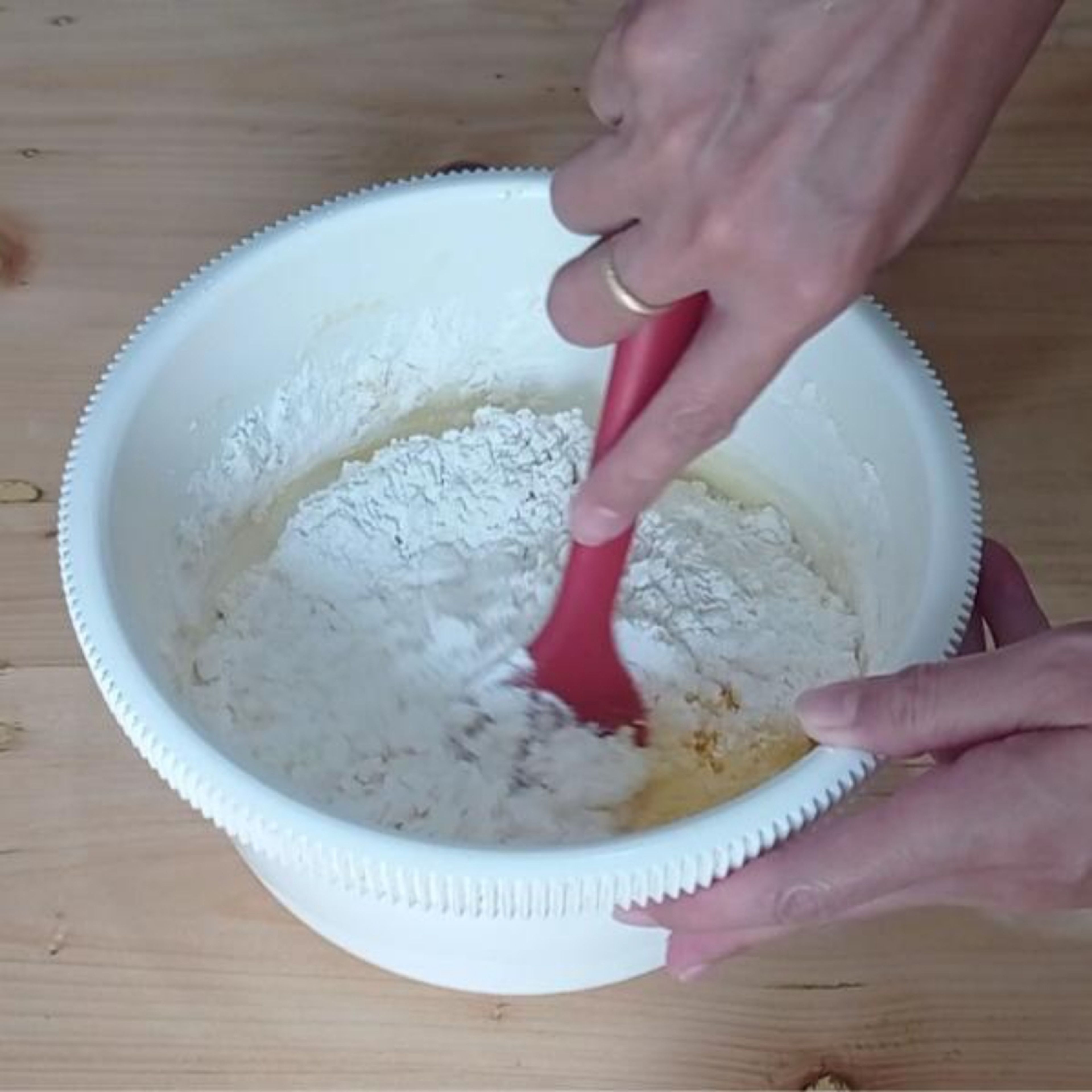 Sift the flour and baking powder into the butter mixture and mix well with spatula until there are no more flour streaks.