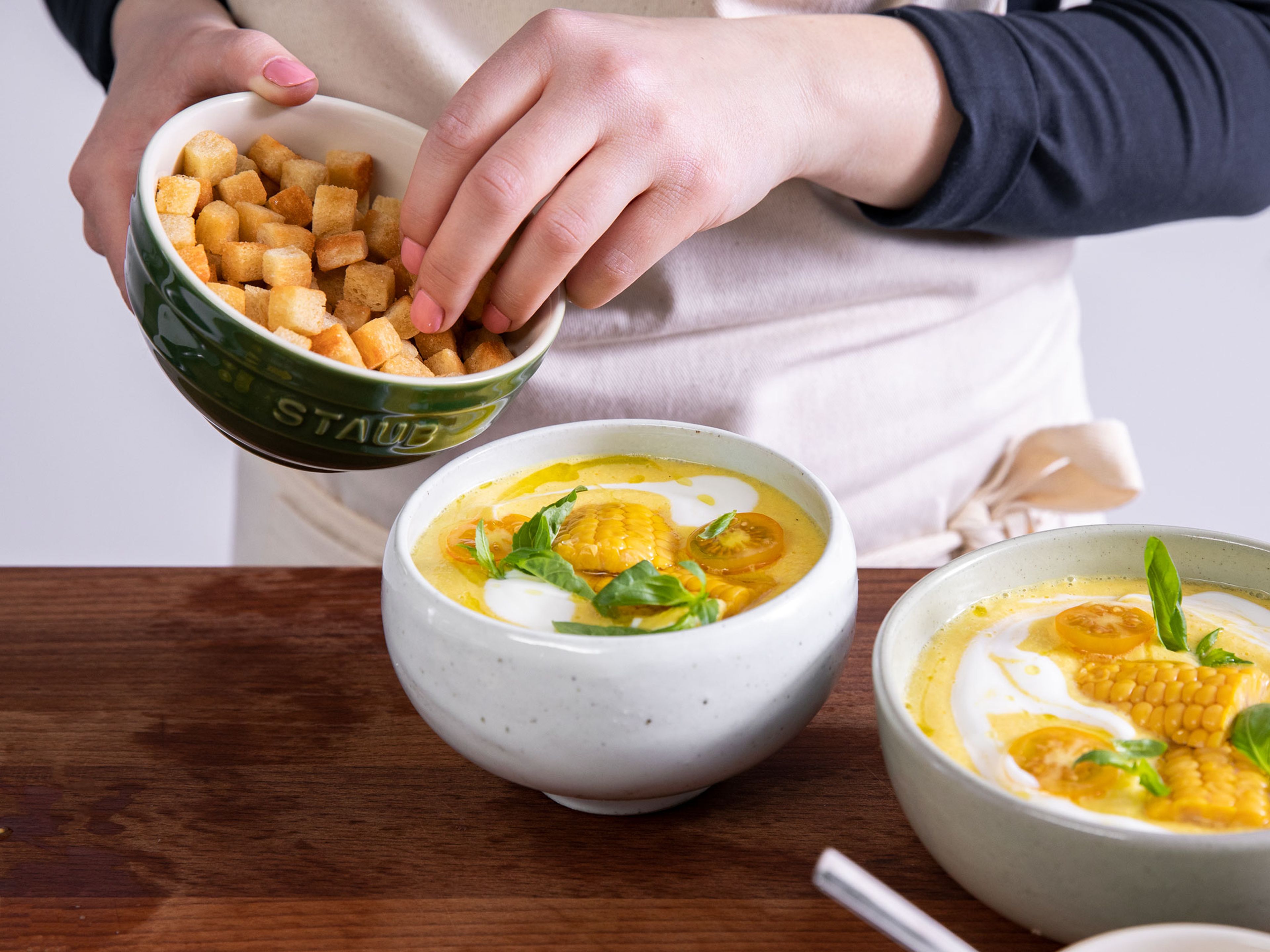 Cut corn kernels from remaining cob and halve yellow tomatoes for serving. Serve gazpacho in bowls with corn, tomatoes, fresh basil leaves, and croutons. Drizzle with yogurt and olive oil. Enjoy!