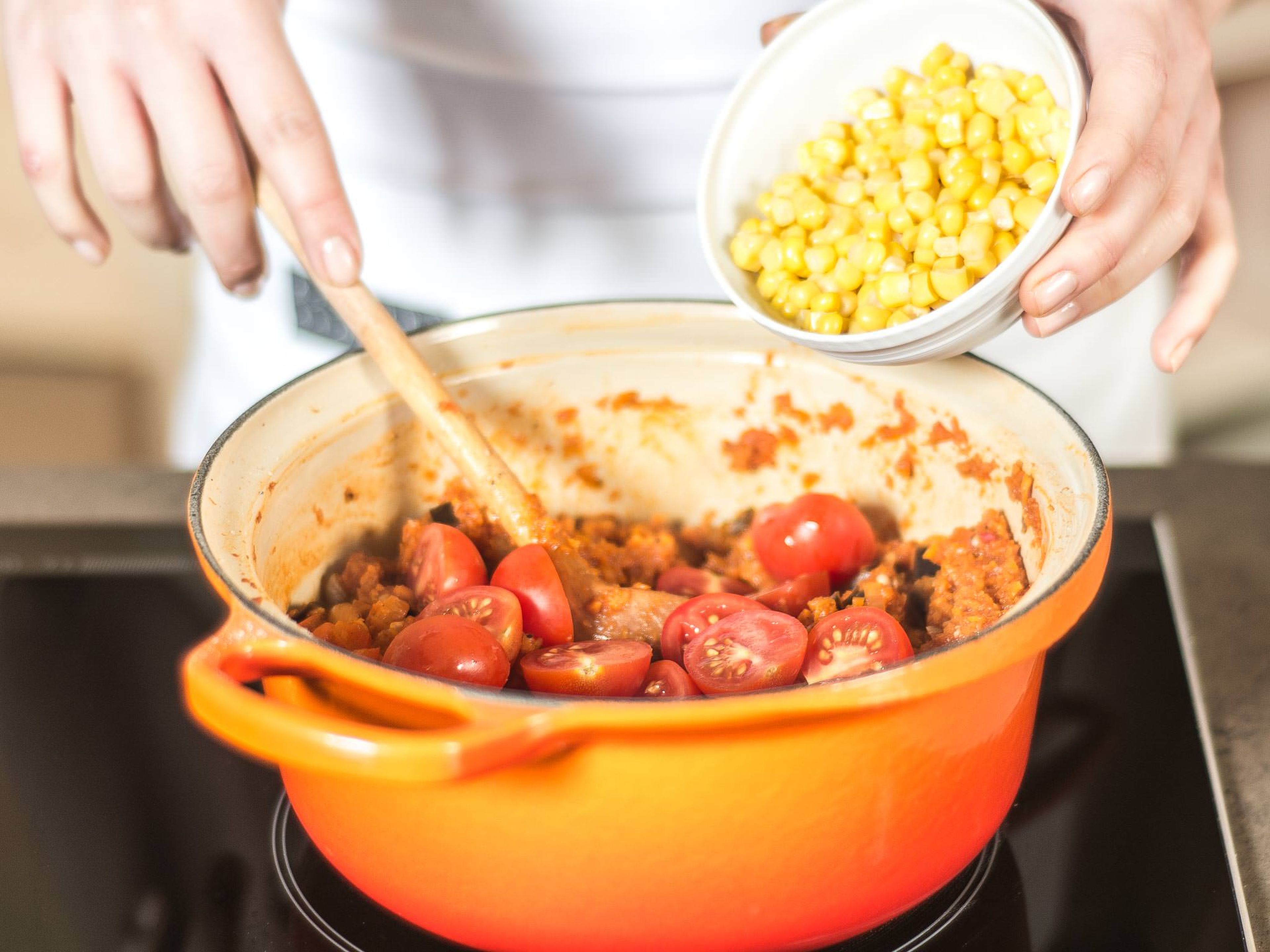 Add cherry tomatoes and corn to the cooked vegetables, and briefly return to a boil. Next, season with cumin, sugar, salt, and pepper. Stir in basil.