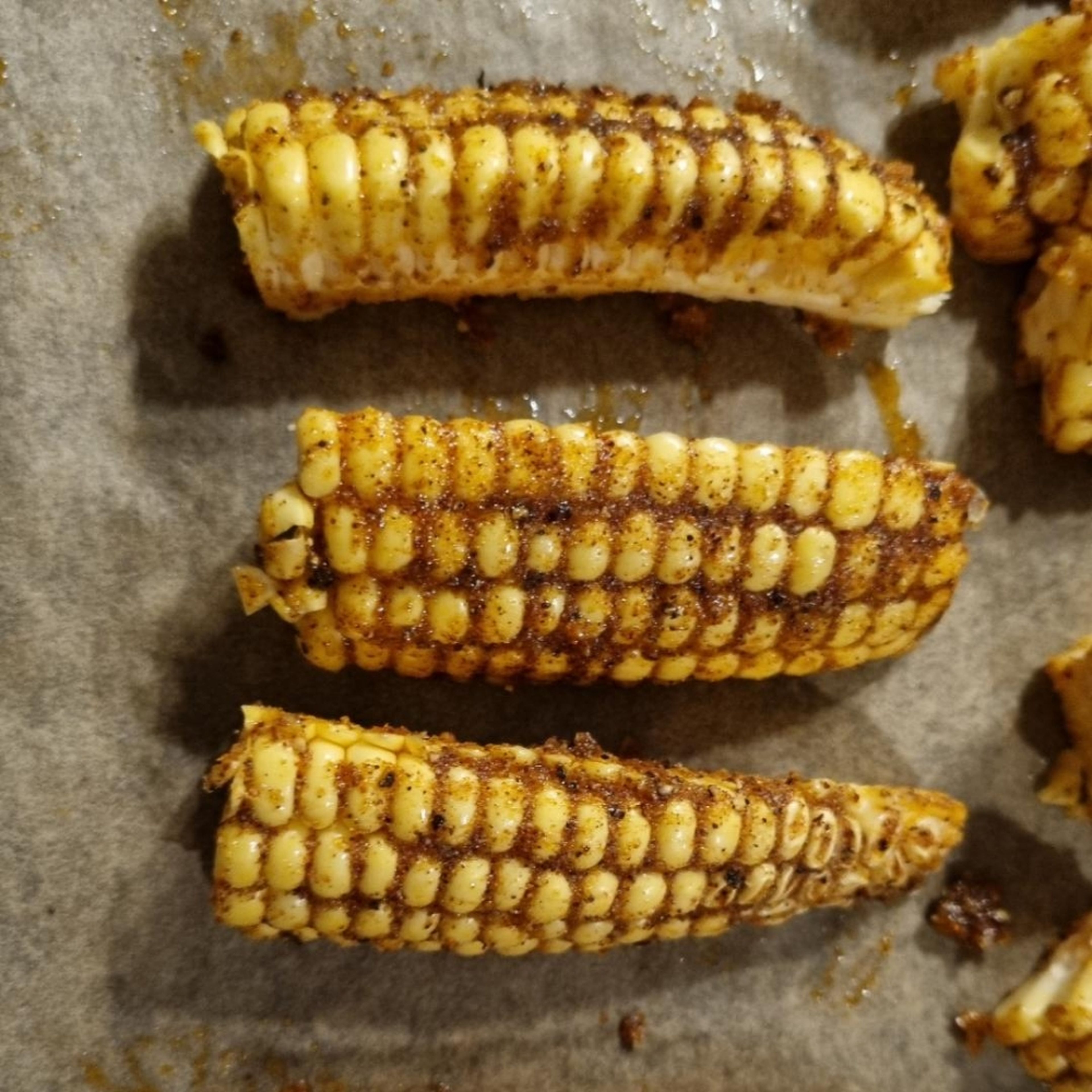 Rub the mix on to the corn riblets and place them on a baking tray lined with a baking paper. Put the tray into the pre-heated oven for 15 min. Check after 10 min to see if they are browning.