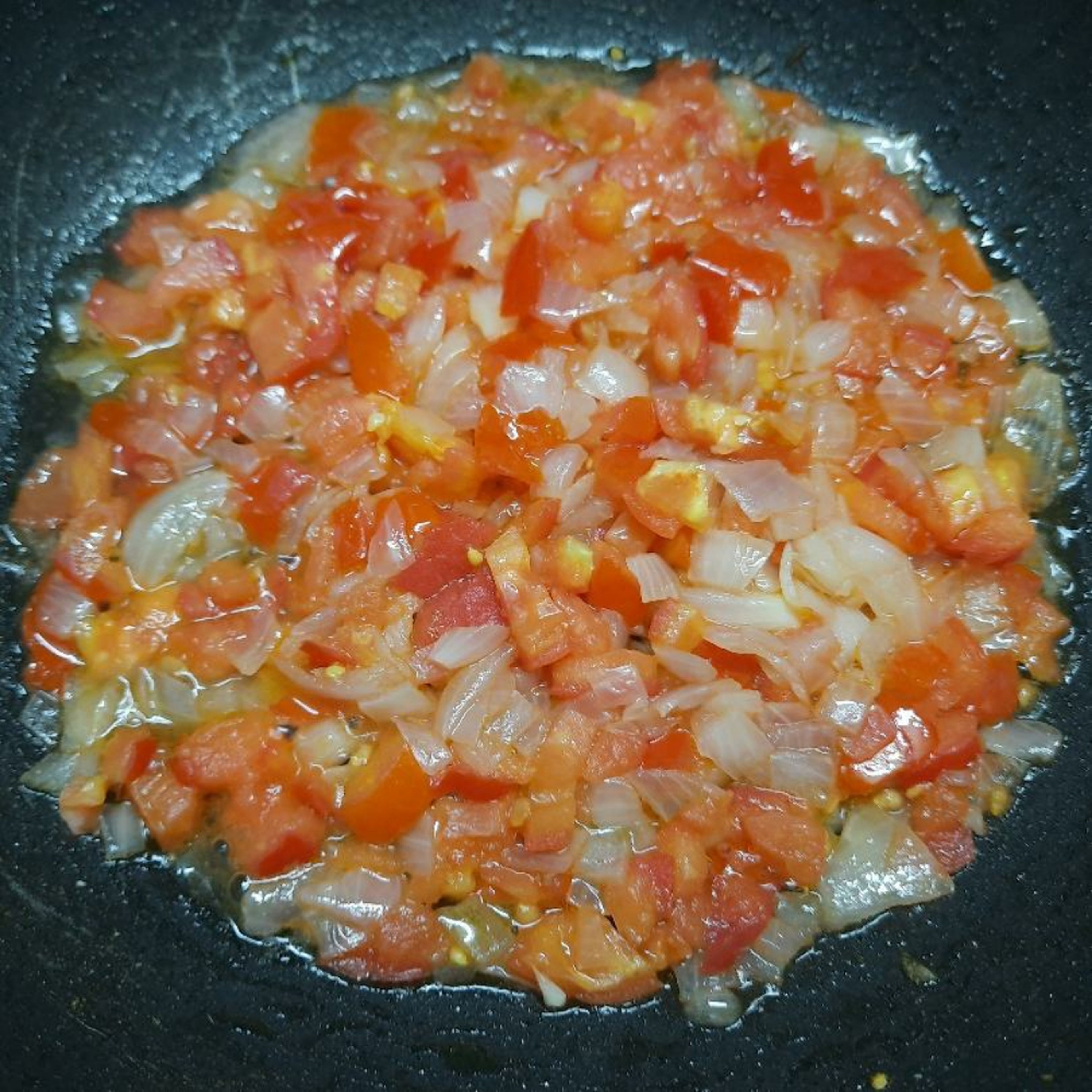 Add the tomato pieces and mix well. Close the lid and let it cook for 2mins. When you open the lid, you should see a little water leaving the mixture. This is the natural water in the tomatoes.