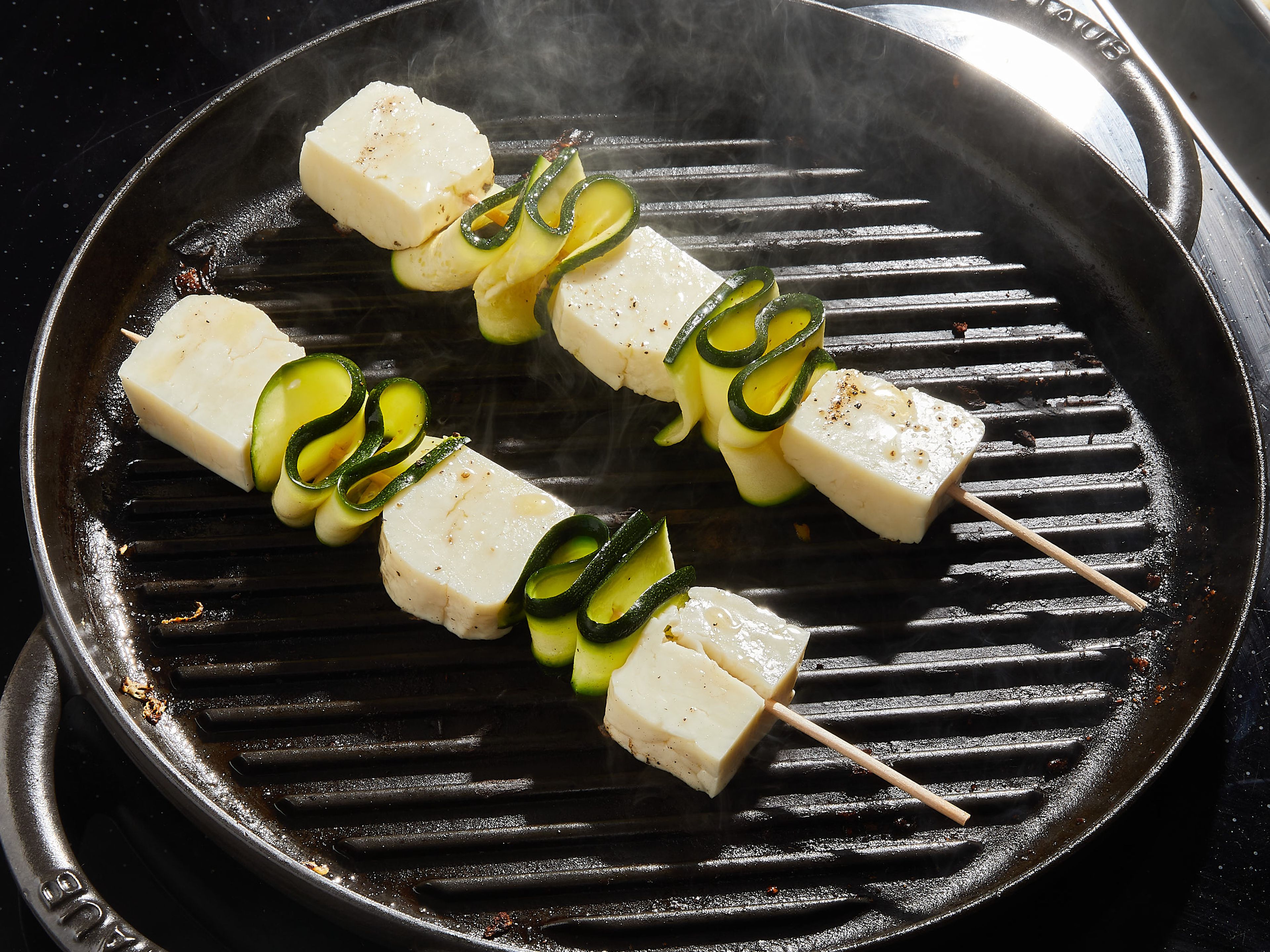 Sear evenly on all sides on a preheated grill or grill pan, about 10-17 min. or until the skewers are well browned. Transfer to a large plate and immediately drizzle with a little more olive oil and lemon juice. Sprinkle with chopped mint and the toasted sesame seeds. Enjoy!
