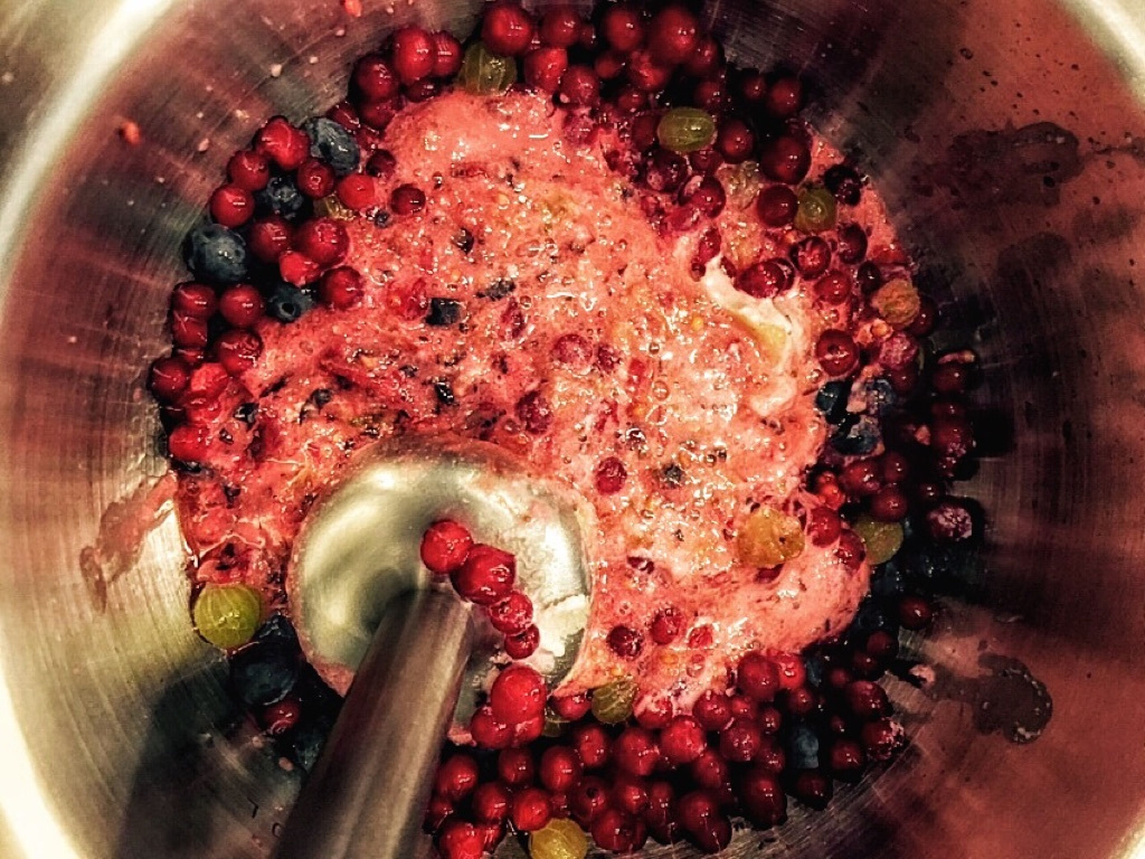 Wash berries, put in a bowl with marzipan, and purée.