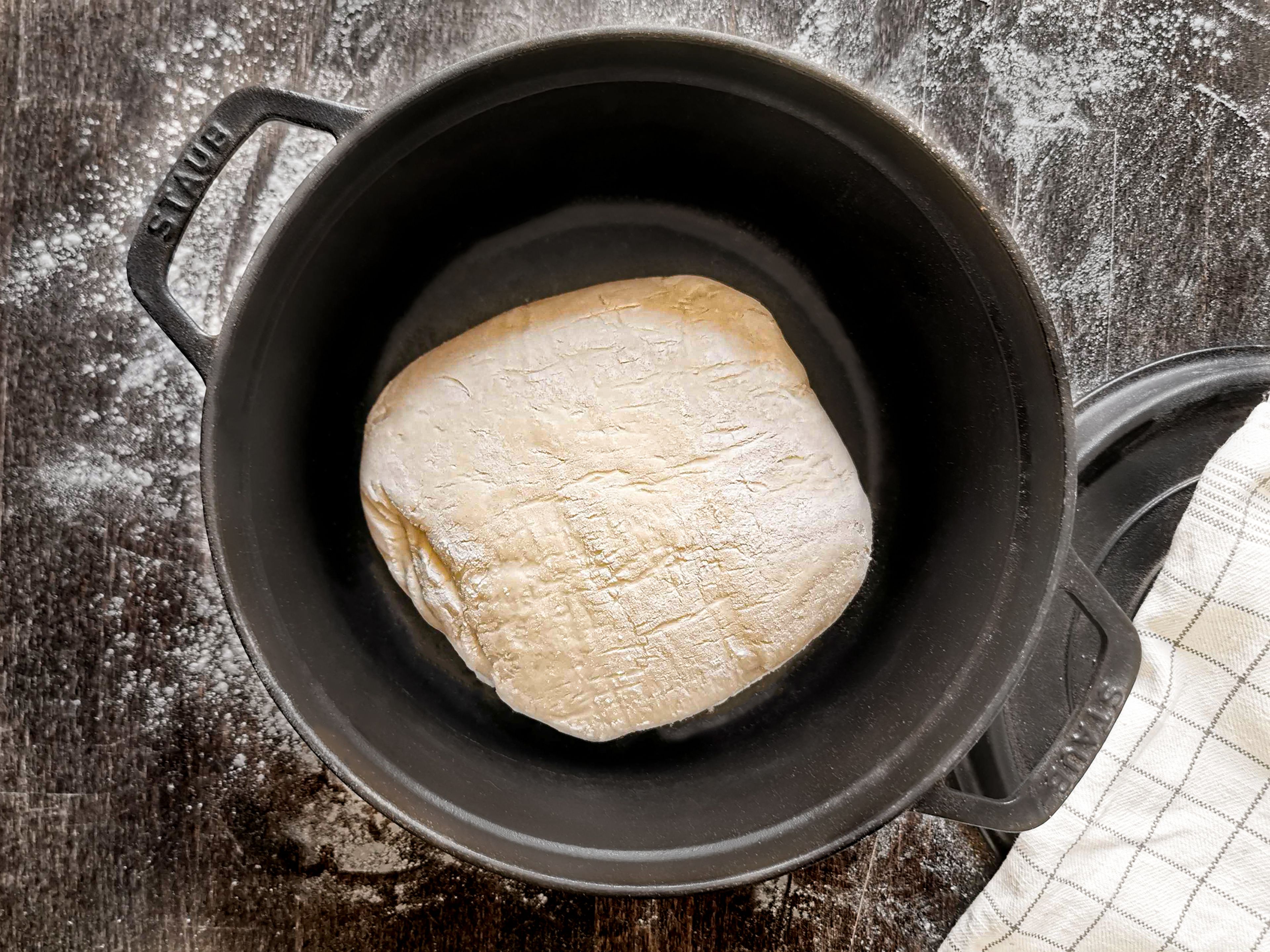 Preheat the oven to 250°C/480°F and heat the pot with a lid on an oven rack. Carefully remove the preheated pot and put the dough into the pan with the seam side down. Score it quickly if desired, then cover and bake the bread for approx. 30 min. Remove the lid and bake for another 15 to 30 min. if you want a darker crust.