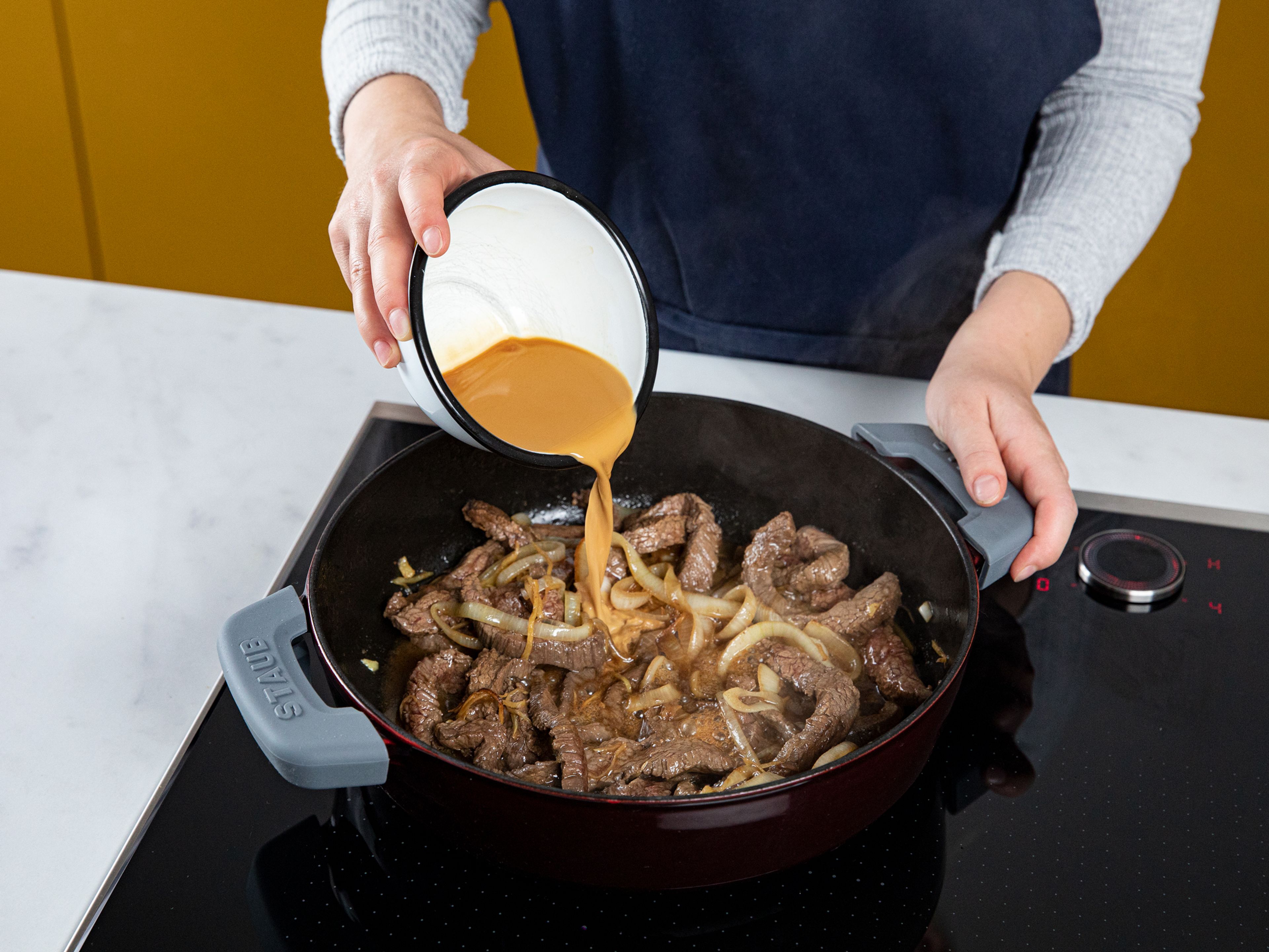 Add soy sauce mixture to the pan and cook until sauce thickens. When the beef is cooked through, remove from heat and stir in butter. Serve with rice and enjoy!