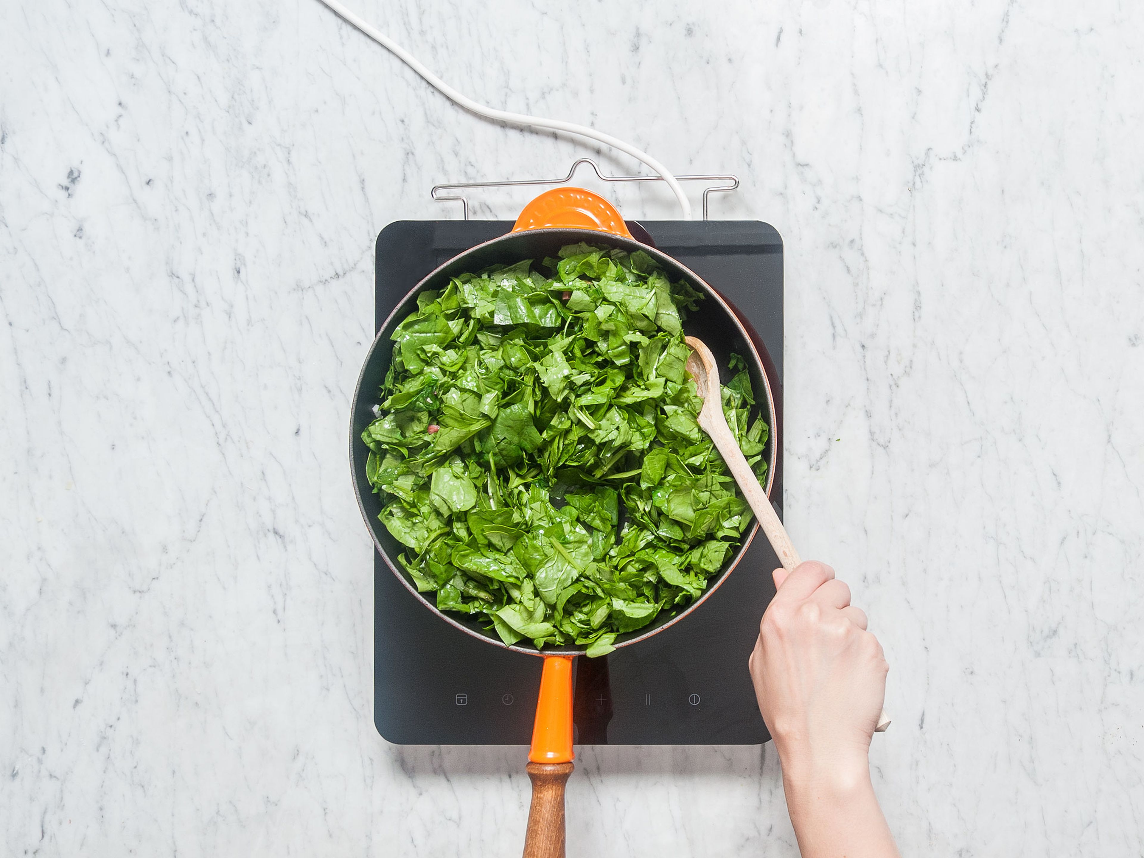 Heat olive oil in a large frying pan set over medium heat. Add diced bacon, onion, and garlic and sauté for approx. 2 – 3 min. Add green onion and spinach, season well with salt and pepper, and fry over medium heat for approx. 4 - 5 min.