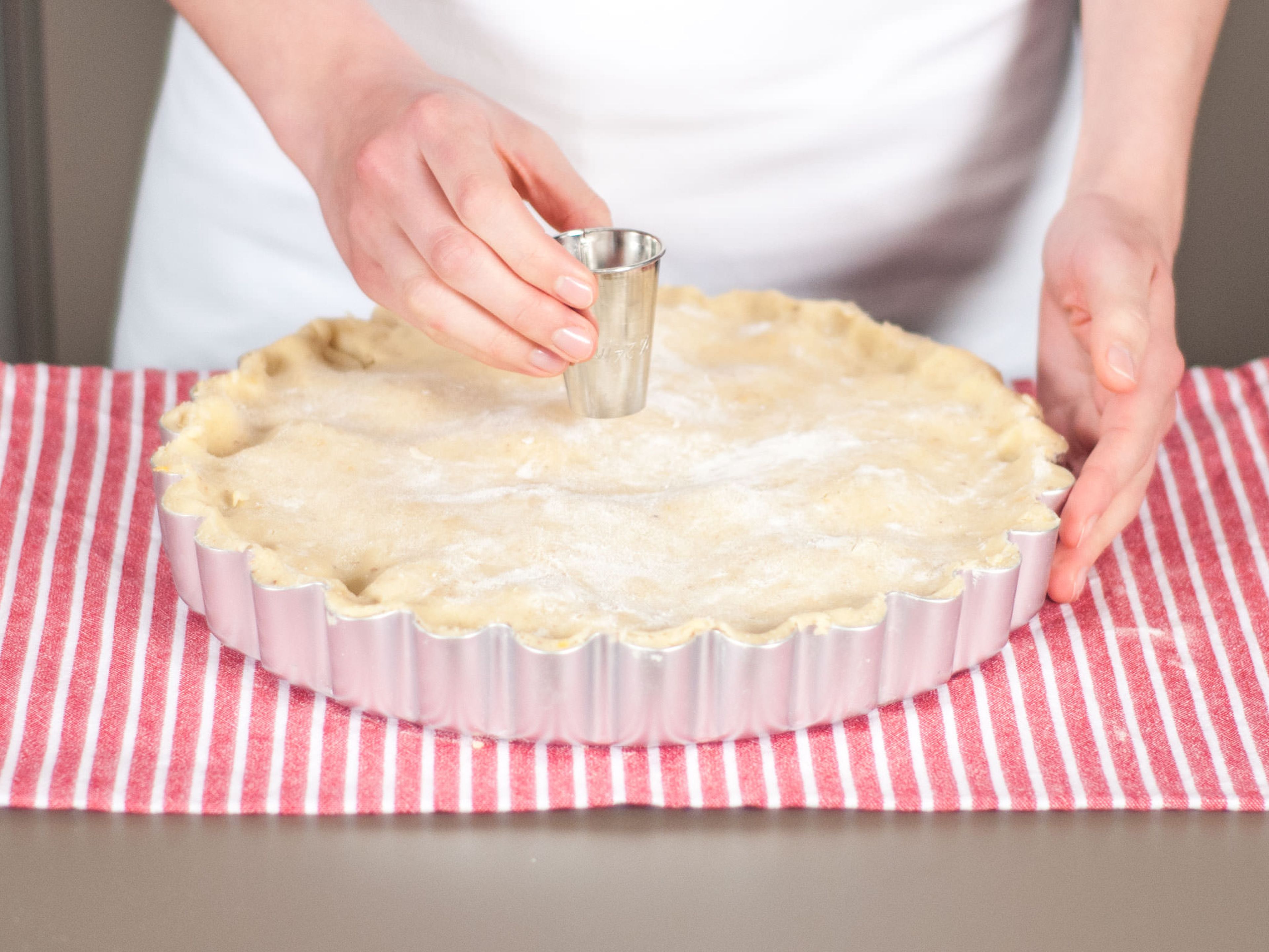 Place second half of dough on top and seal around edges. Make a small hole in the middle of the pie with a round cookie cutter to allow air to escape while baking. Place pie in preheated oven at 160°C/325°F and bake until golden brown for approx. 65 - 75 min. Enjoy warm with ice cream or whipped cream.
