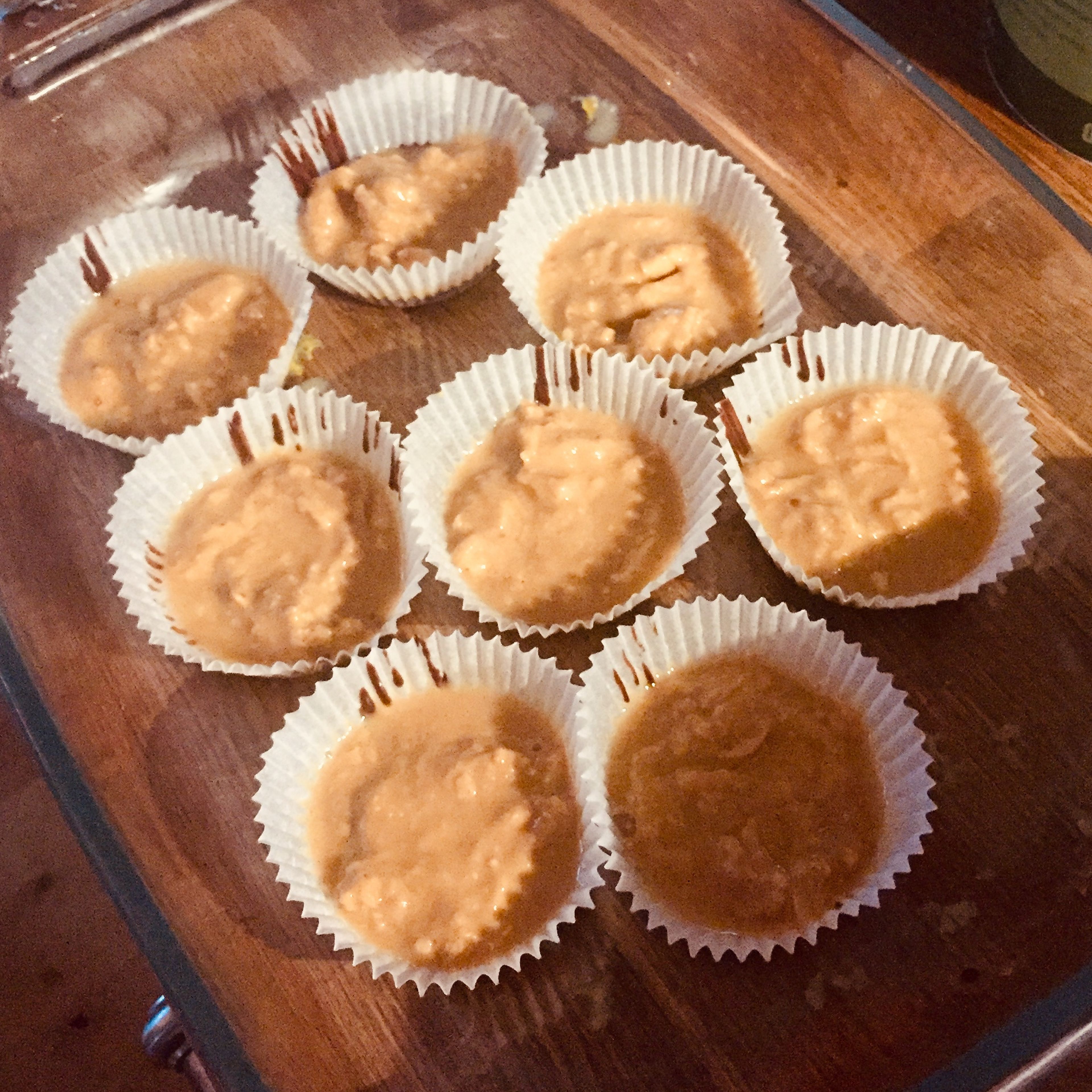 Take the peanut butter cups out of the freezer and add a thin layer of unsweetened peanut butter.
