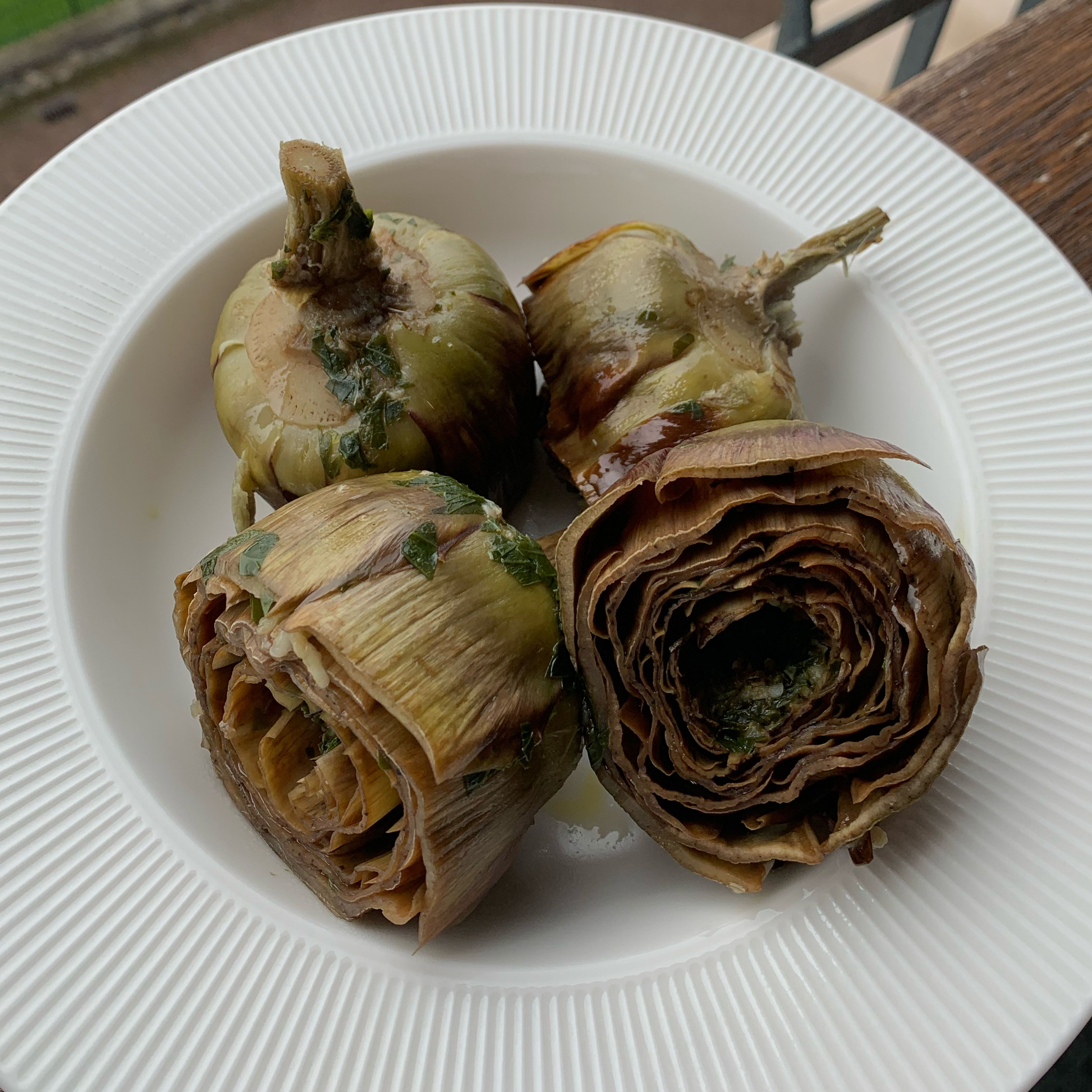 When the artichokes are ready, place them on a beautiful plate and serve them warm to your guests. 
