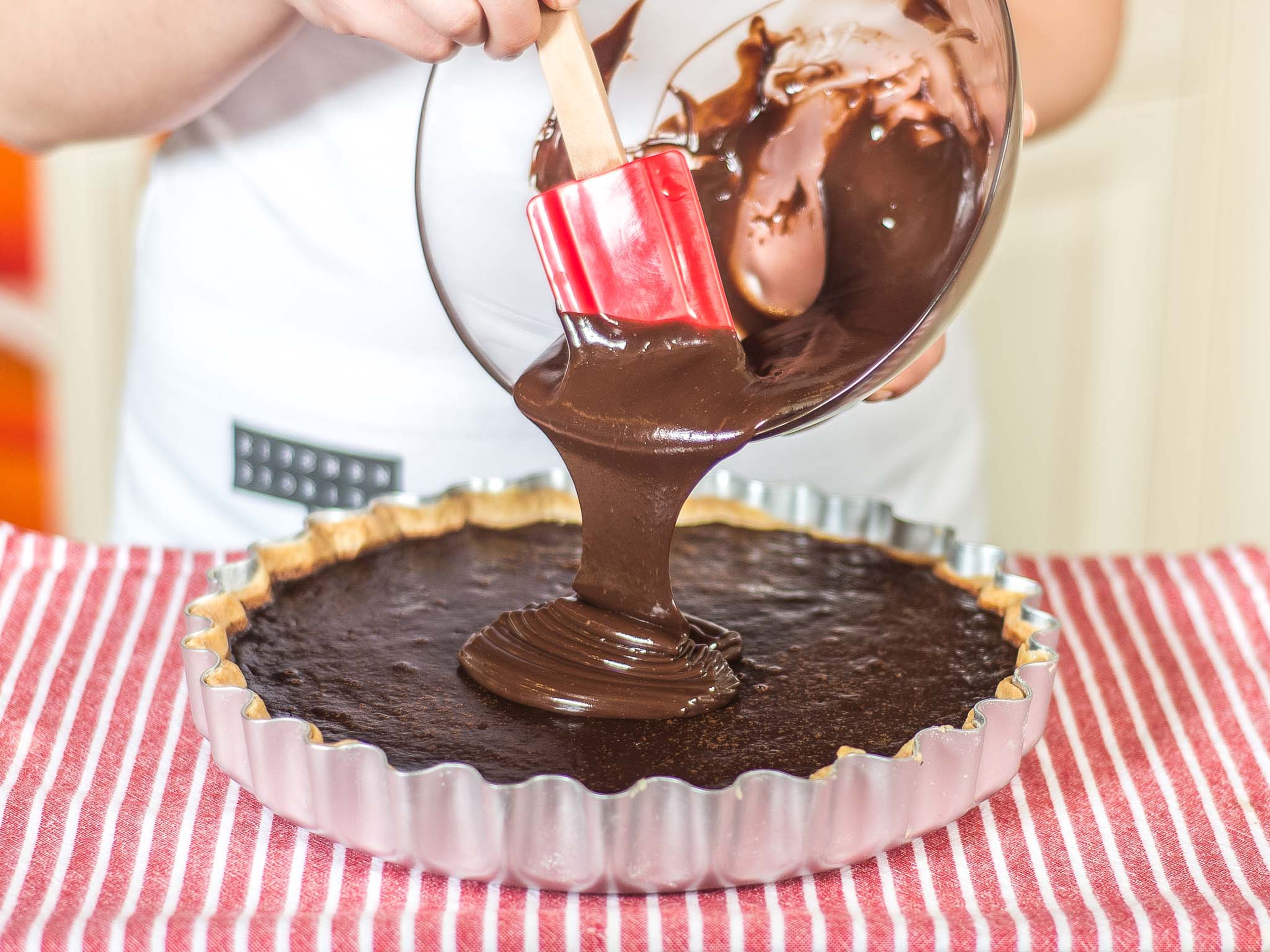 Spread the ganache over the cooled tart. Chill the tart for at least 1 hour before serving. Serve with a garnish of cream and fresh berries, as desired.
