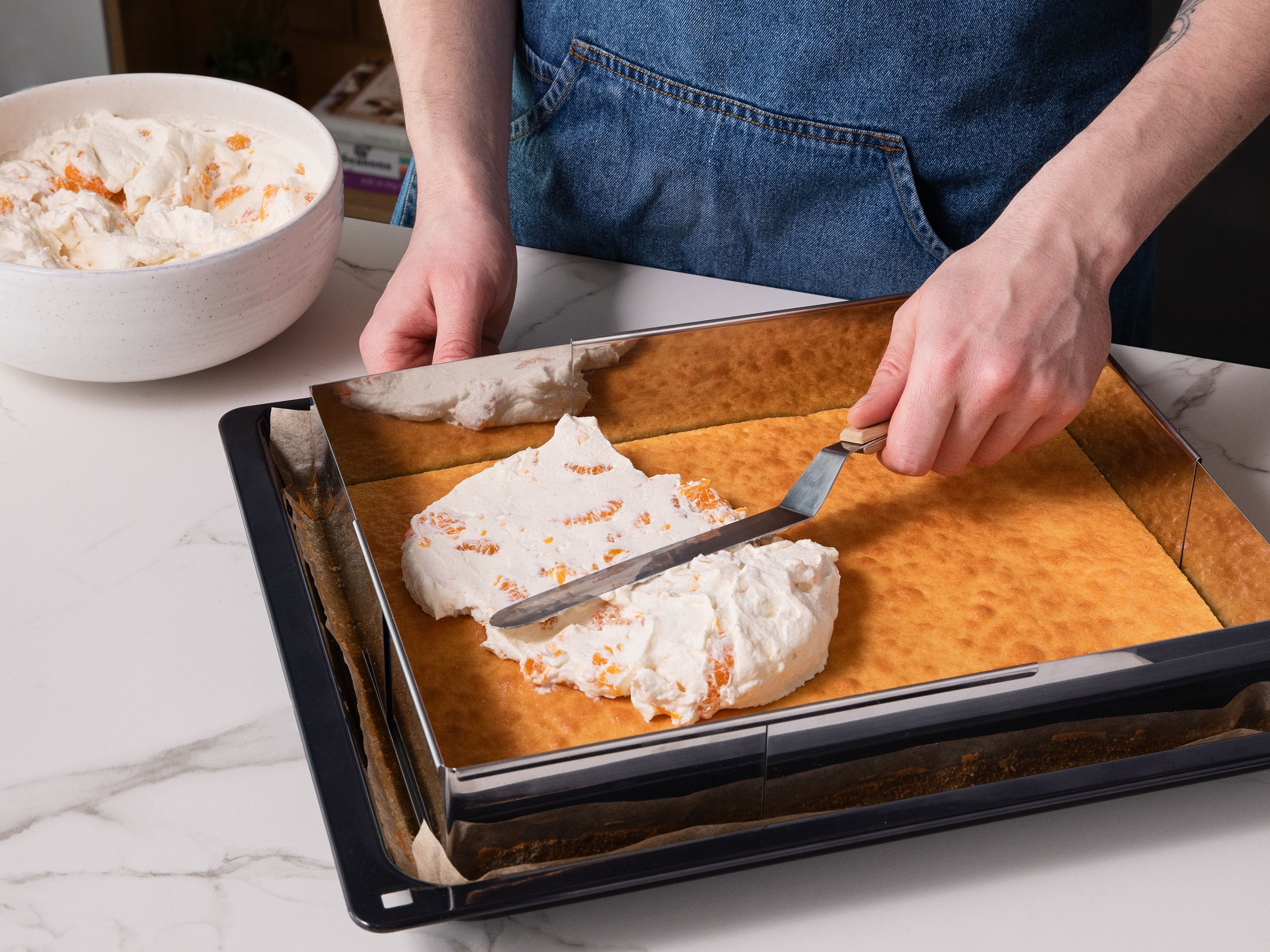 For the frosting: Whip cream with sugar, vanilla sugar, and stabilizer. Mix the schmand (or crème fraîche) until smooth, then fold in whipped cream and drained mandarins. Spread the frosting over the cooled cake, mix cinnamon with sugar and sprinkle the cake with the mixture. Chill before serving.