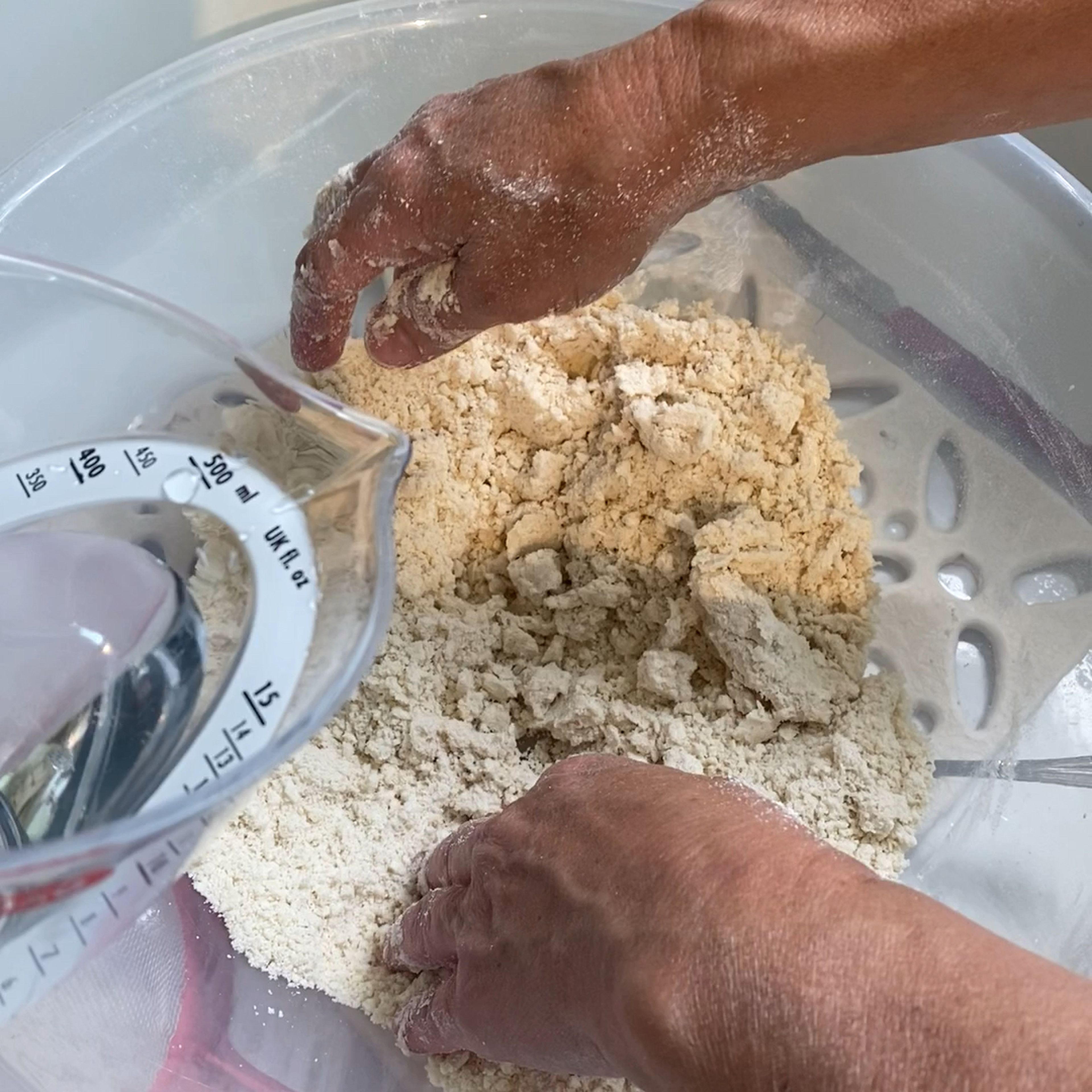 Gradually add the water and then salt to start making it into a dough 