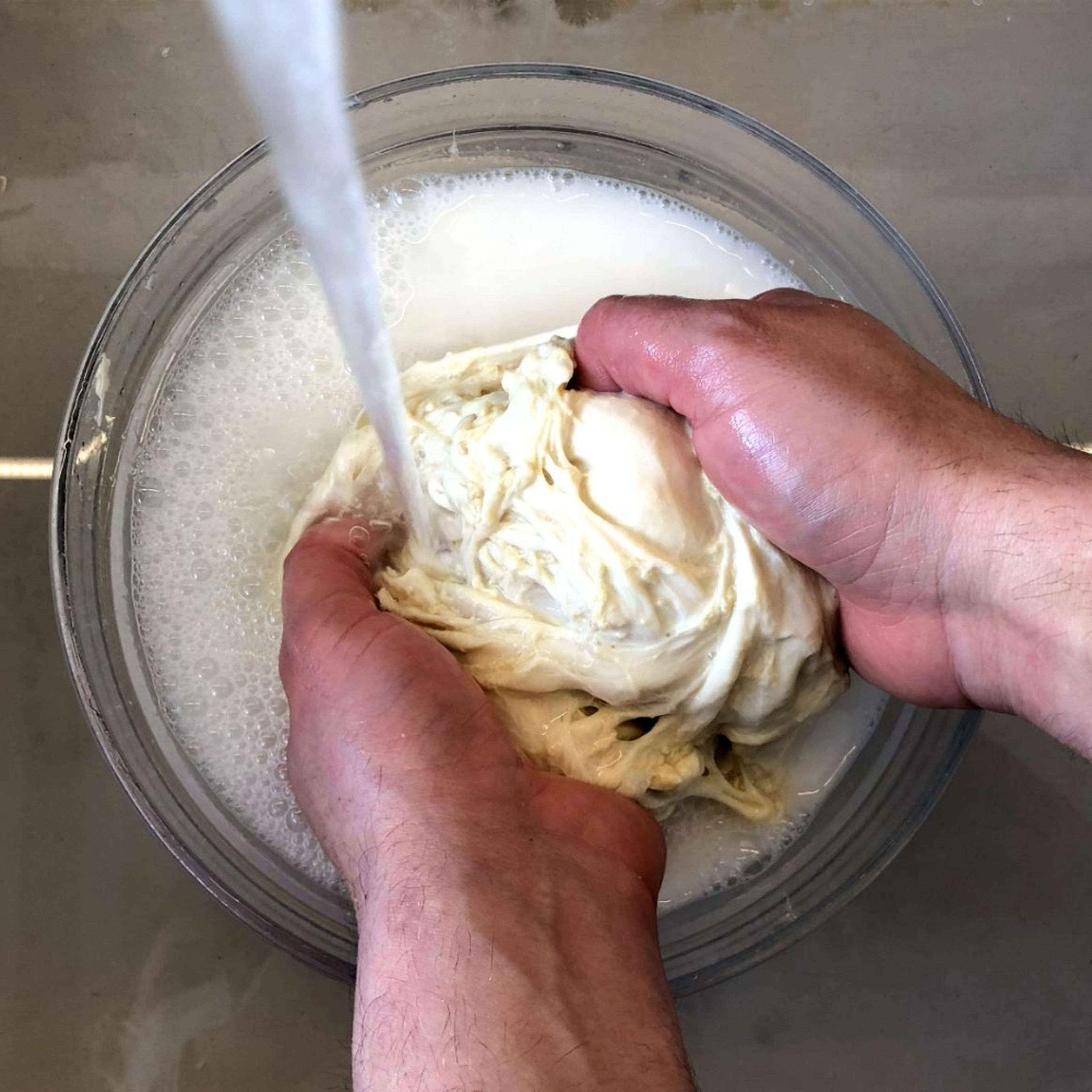 Rinse the dough thoroughly under cold water until the water in the bowl runs clear.