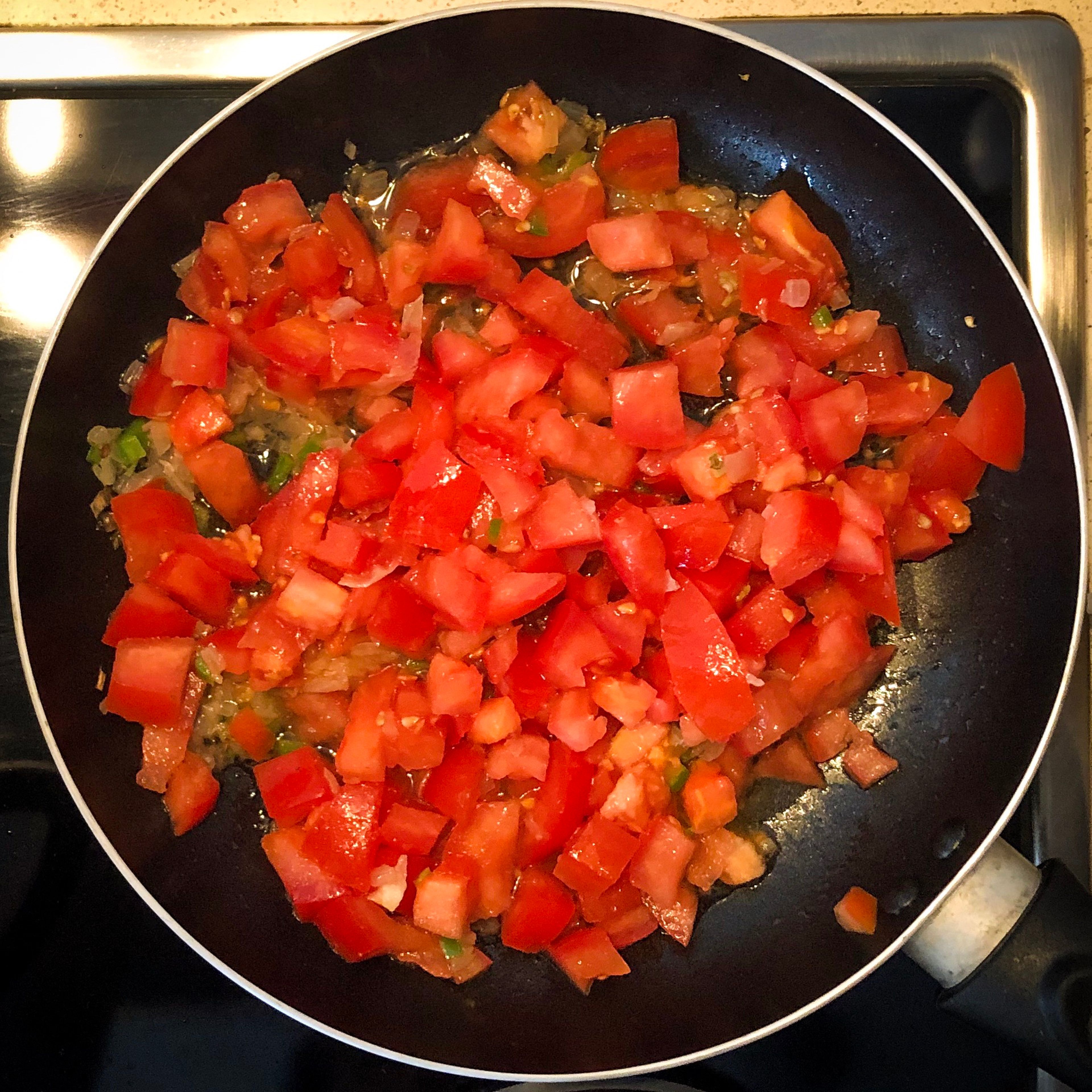 Fourth step: add your cubed tomatoes and let them cook until almost dry.