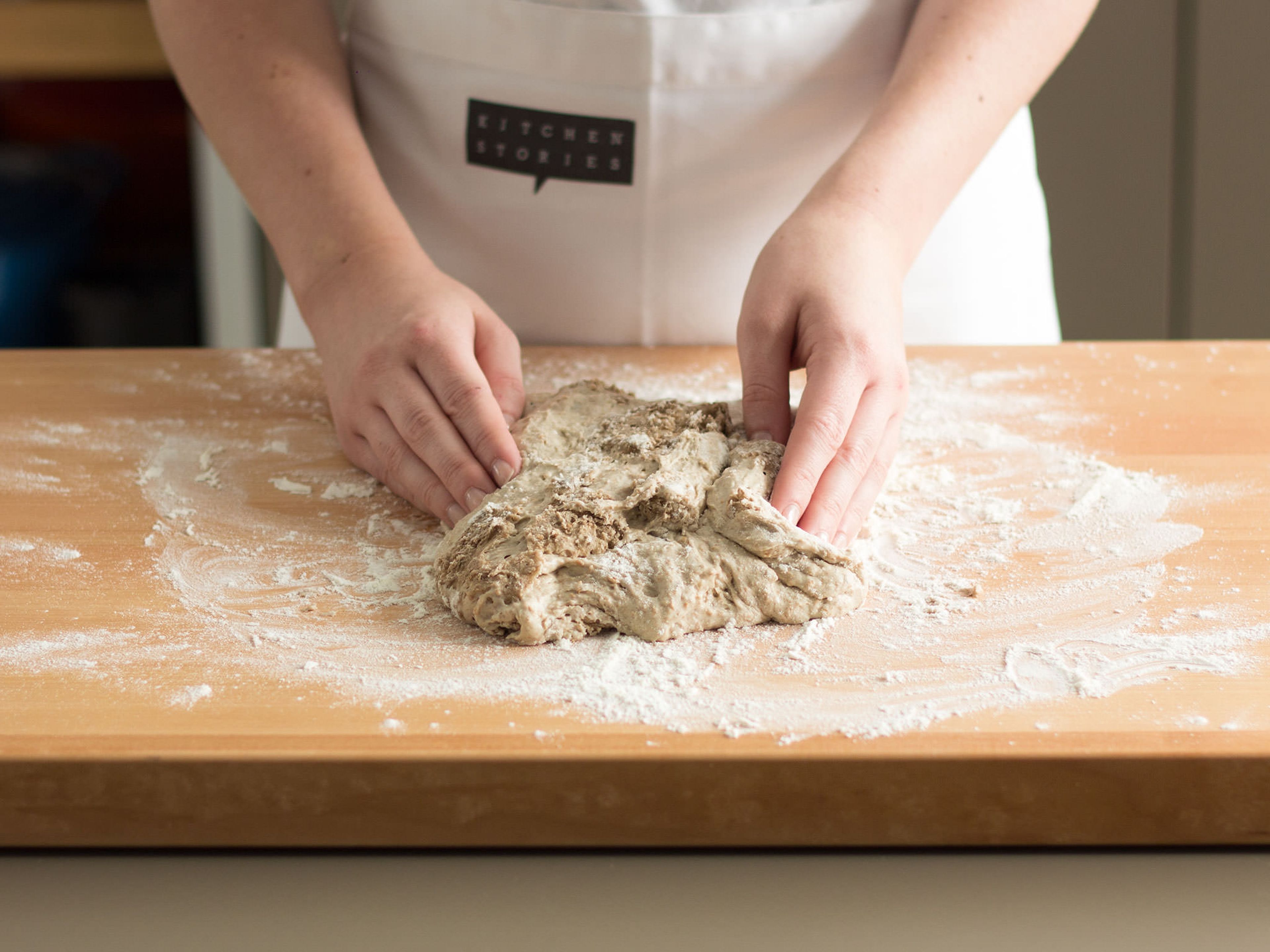 Preheat oven to 250°C/480°F. Generously flour the work surface and slide the dough out of the bowl. Fold each edge of the dough towards the middle.