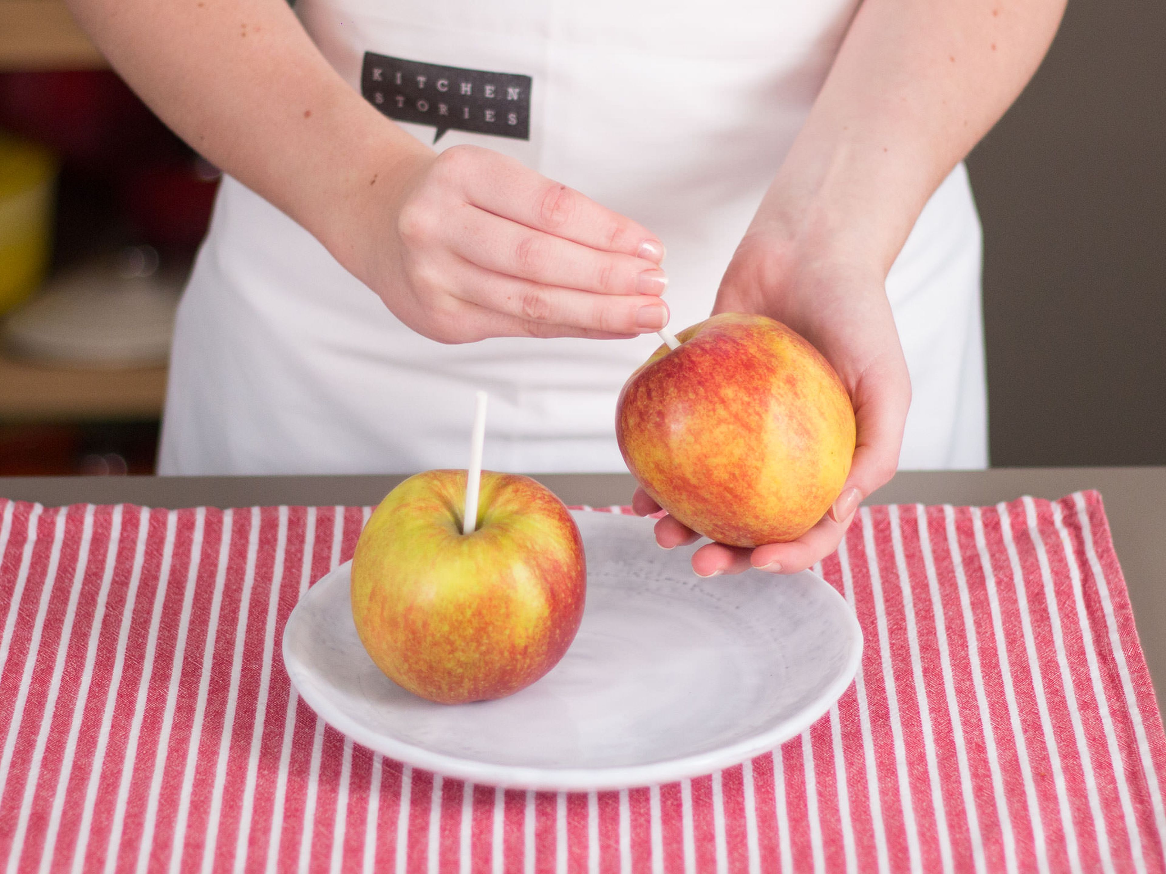 Press a thick wooden skewer into the center of each apple and place in freezer for approx. 1 hr.