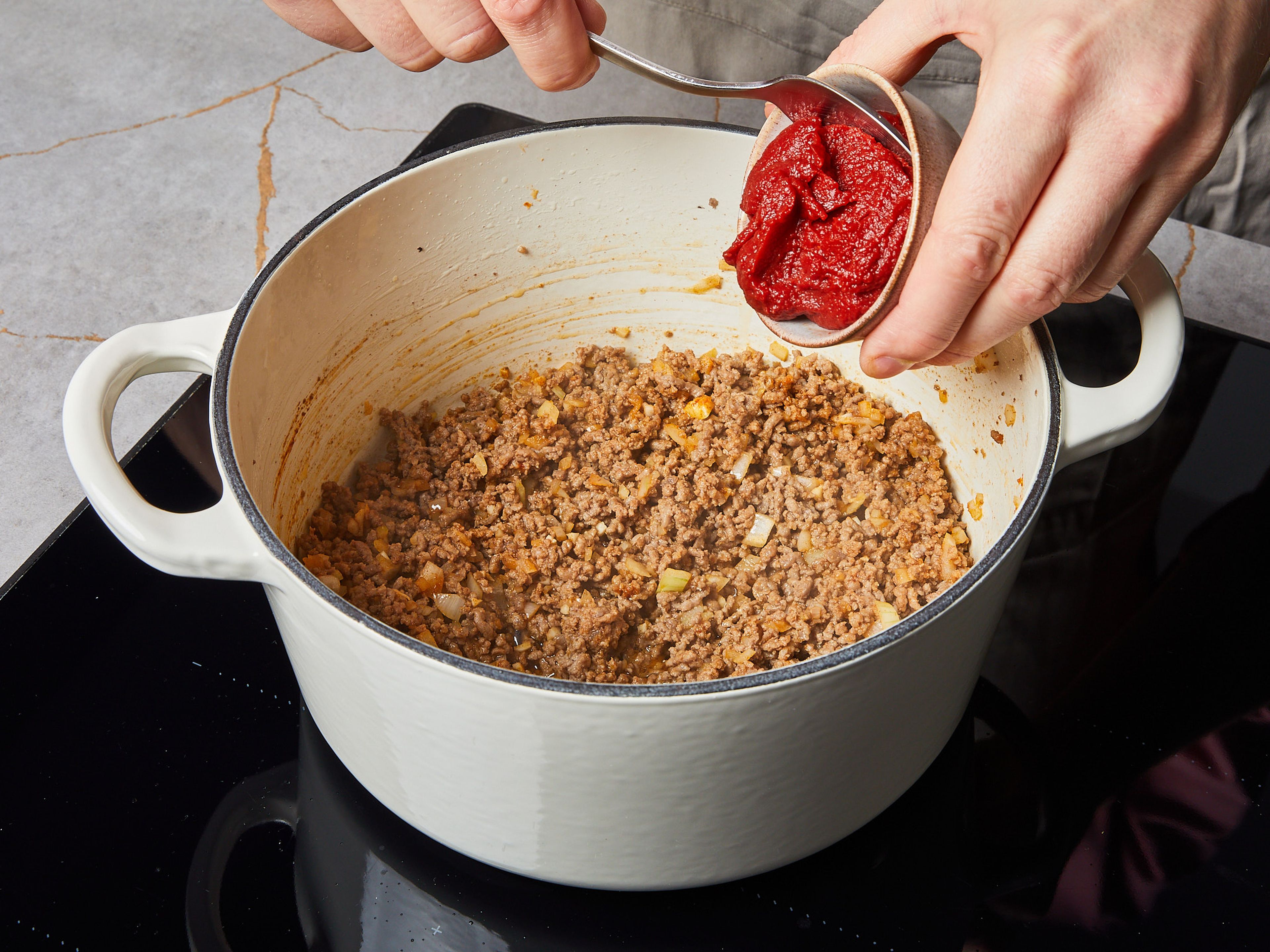 Add tomato paste and continue to sauté for approx. 2–3 min. Season with salt and pepper.