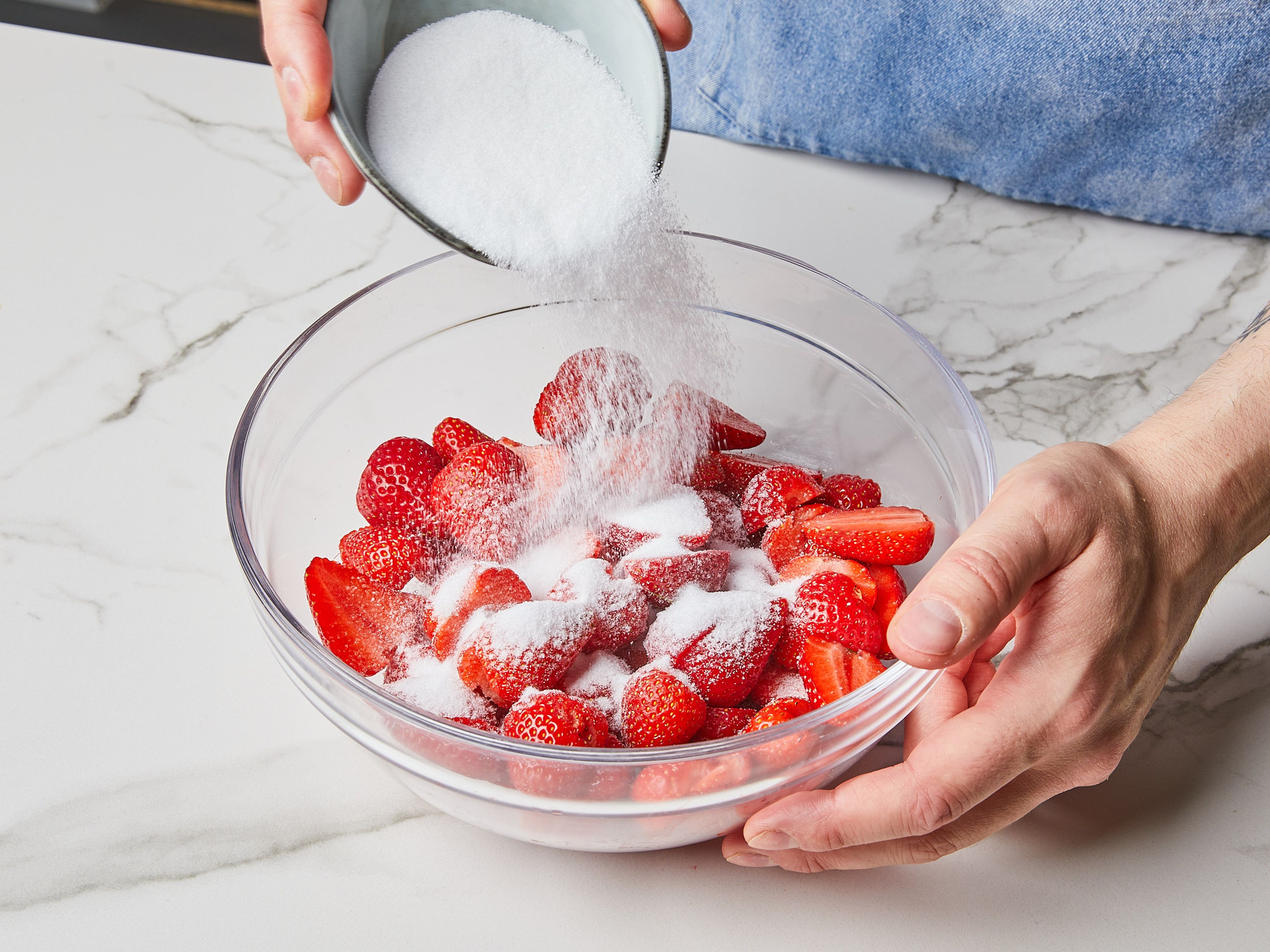 Ein paar Erdbeeren zum Garnieren beiseite legen. Die restlichen Erdbeeren entstielen, vierteln oder halbieren und in eine große Schüssel geben. Zucker über die Erdbeeren streuen, leicht schwenken und ca. 10 Min. ziehen lassen, bis sich der Zucker aufgelöst hat. Dann die Hälfte des Weißweins dazugeben und zugedeckt mindestens 1 Std. oder über Nacht im Kühlschrank ziehen lassen.