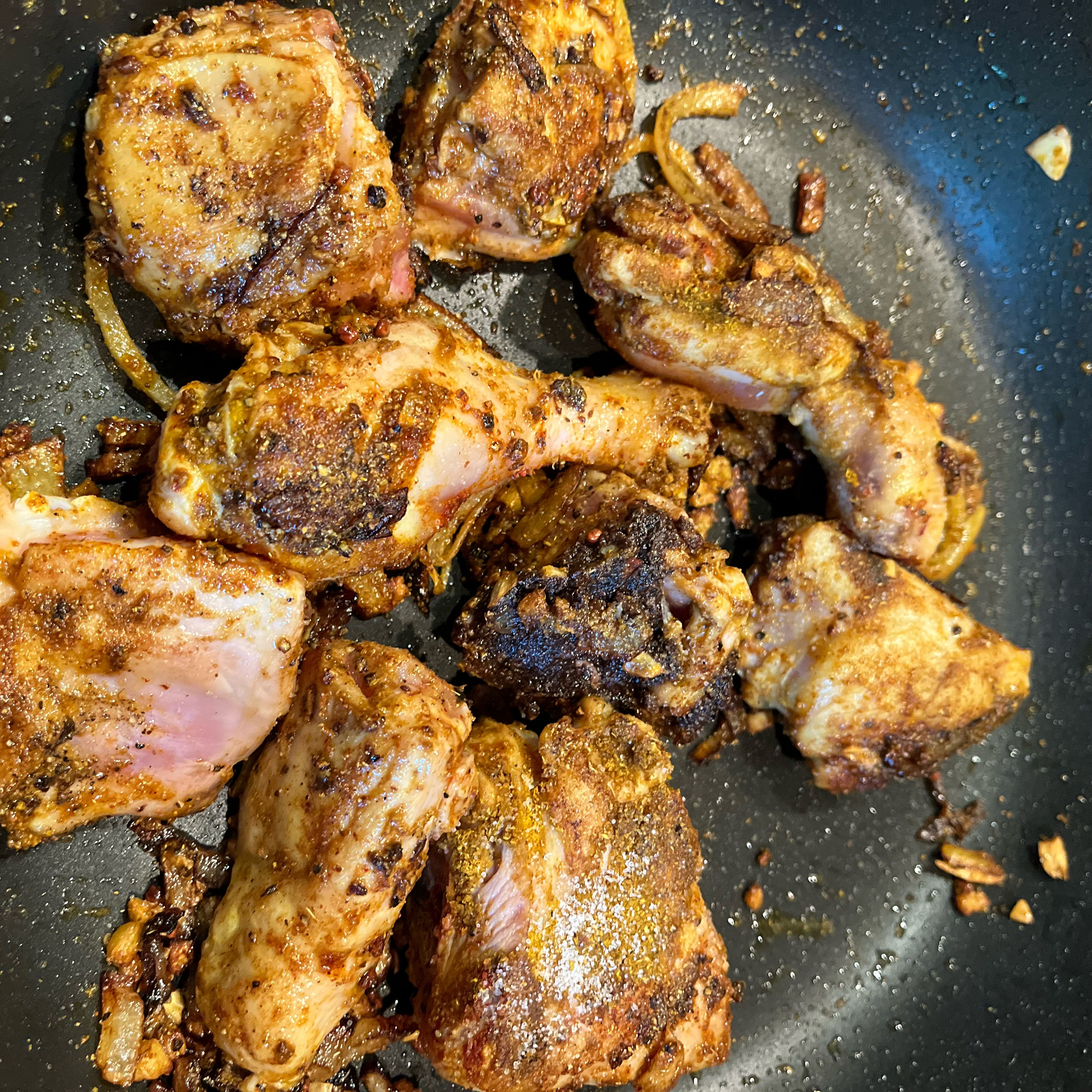 Add chicken pieces and fry until starting to brown. Add madras curry powder, pepper, cayenne pepper, salt and tamarind.  Stir and cook for a few minutes.