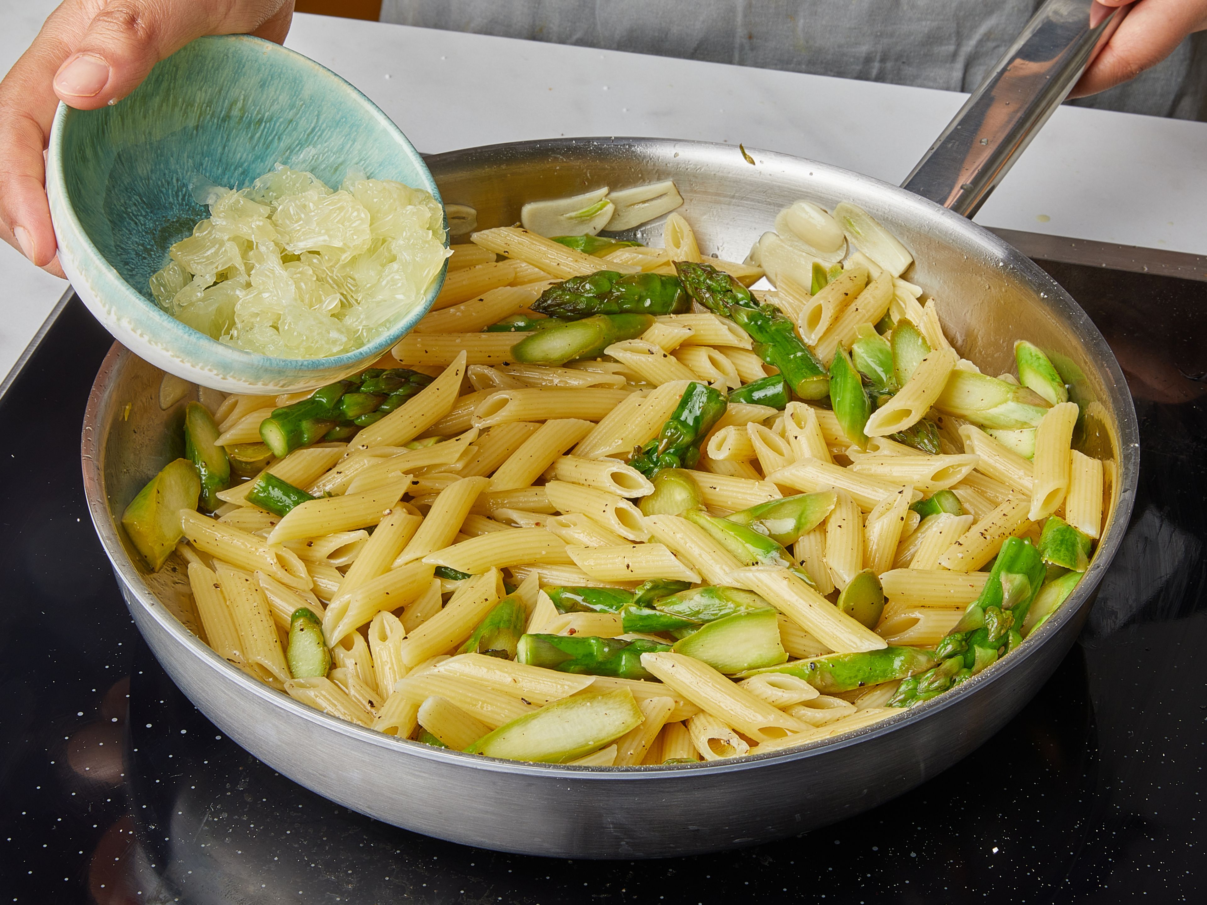 Drain the pasta, reserving some pasta water. Add the pasta to a pan and add pasta water again as needed. Season with salt and pepper. Finally, add the flesh of the lemon and basil and toss everything well. Serve with freshly shaved Parmesan cheese and enjoy!