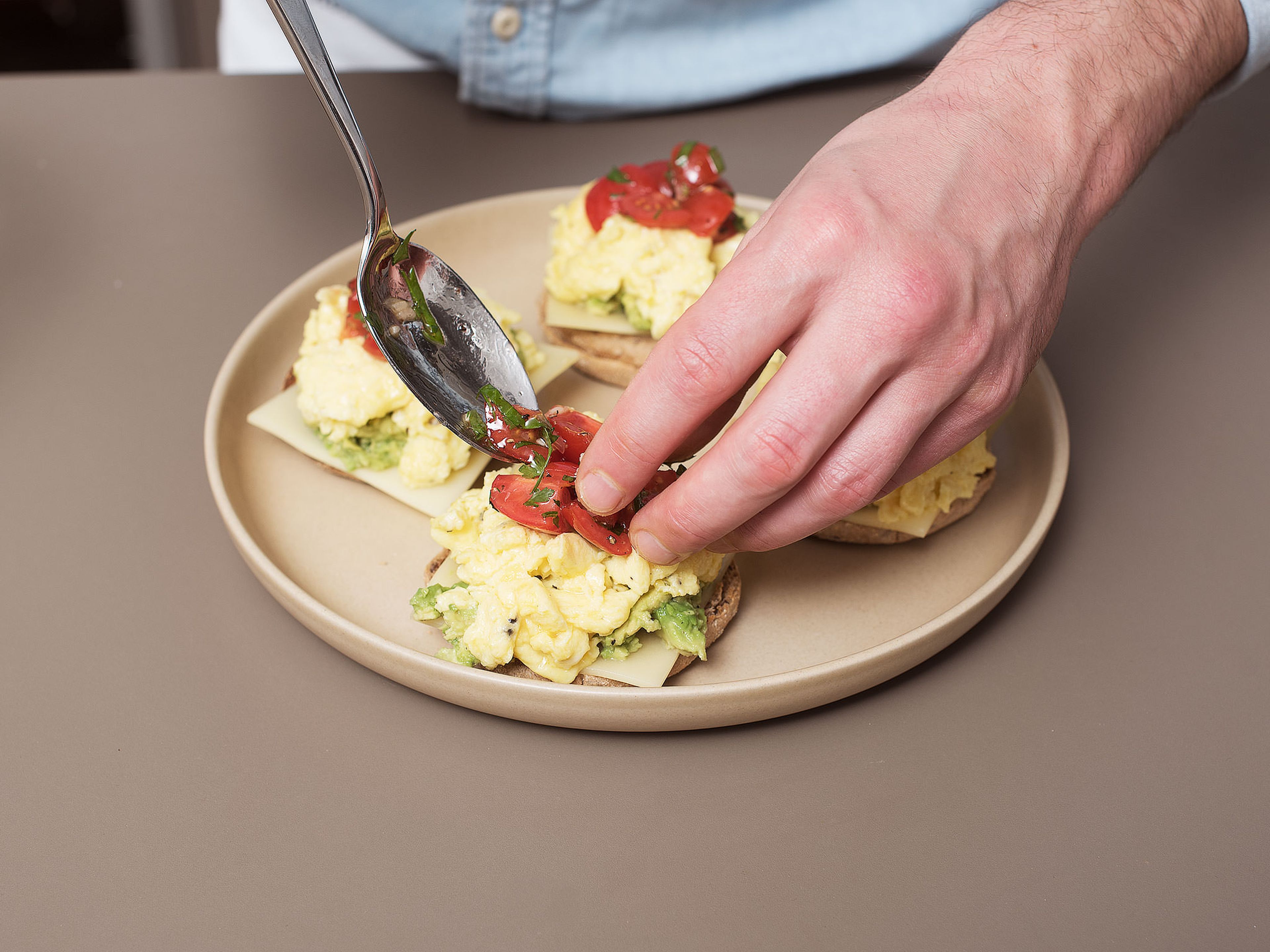 Top each halved English muffin with a slice of Alpine cheese, some avocado, scrambled eggs and salsa. Enjoy!